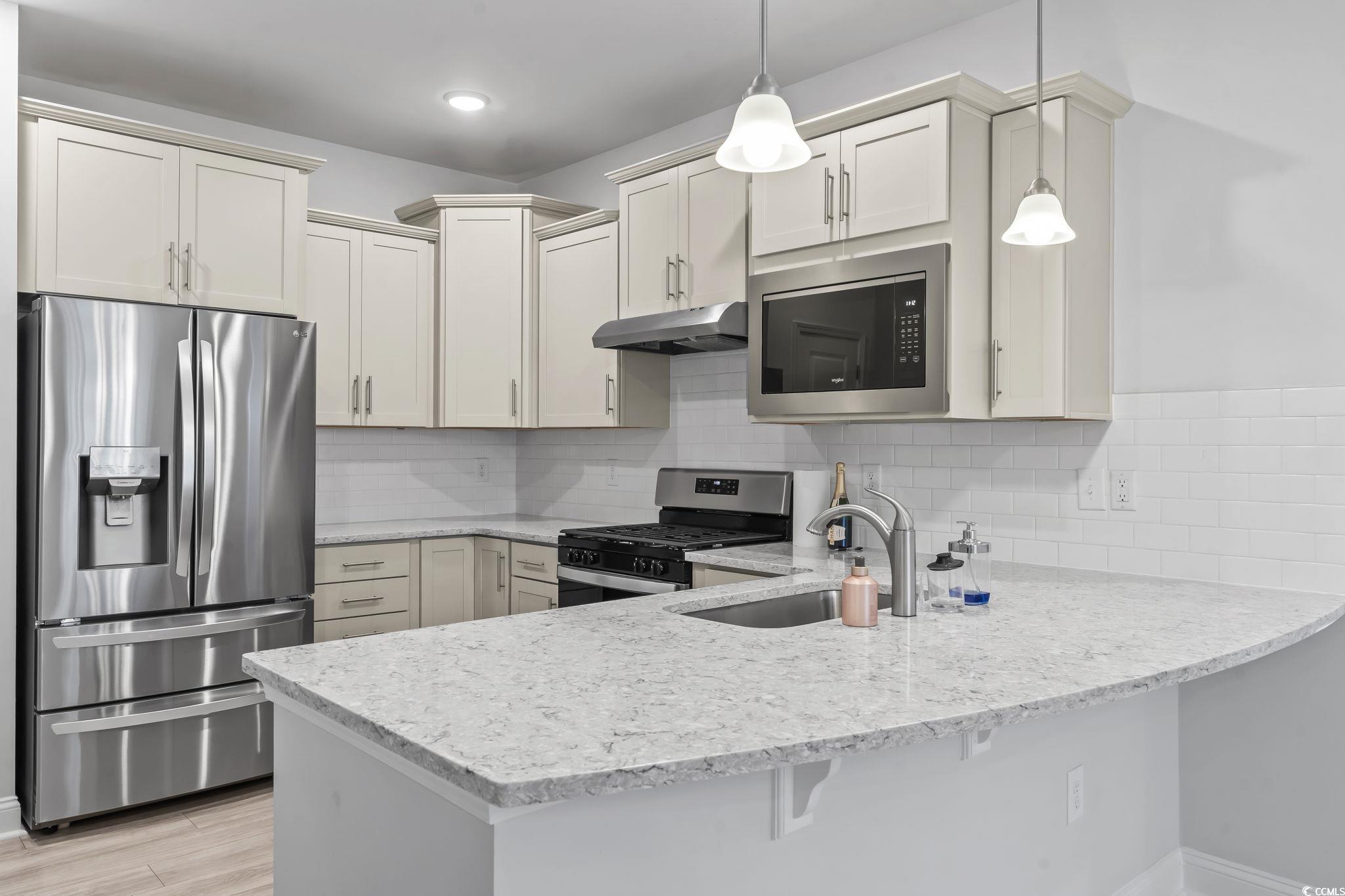 Image 4: Kitchen featuring appliances with stainless steel