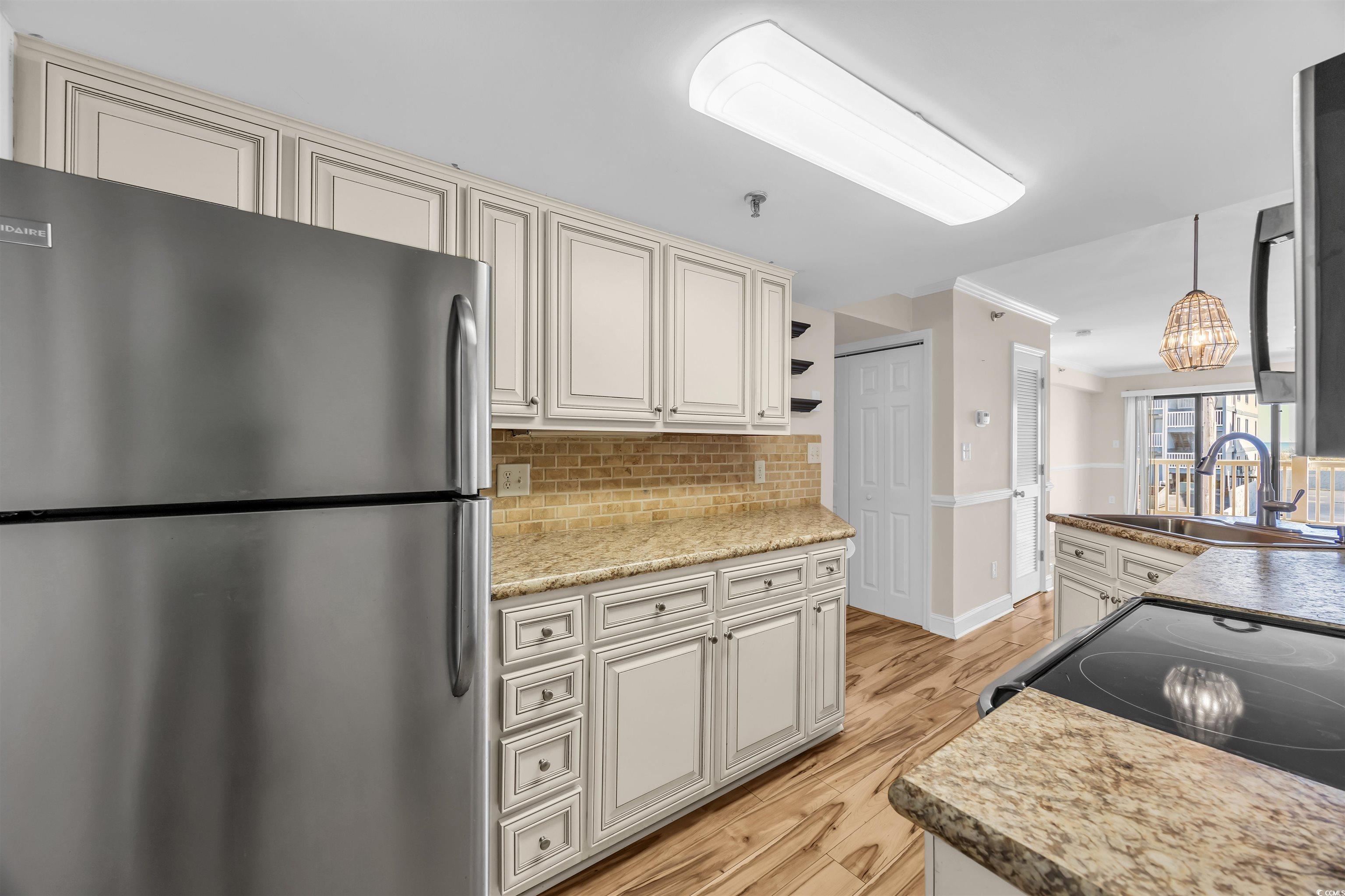 Image 3: Kitchen featuring freestanding refrigerator, light Image 3: Kitchen featuring freestanding refrigerator, light