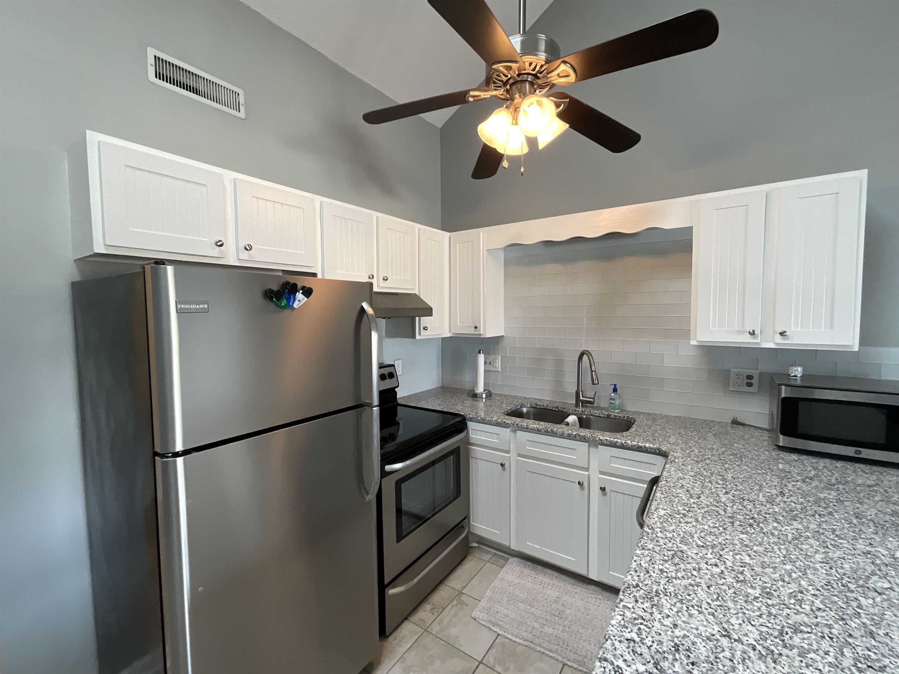 Image 3: Kitchen featuring light stone countertops, stainle Image 3: Kitchen featuring light stone countertops, stainle