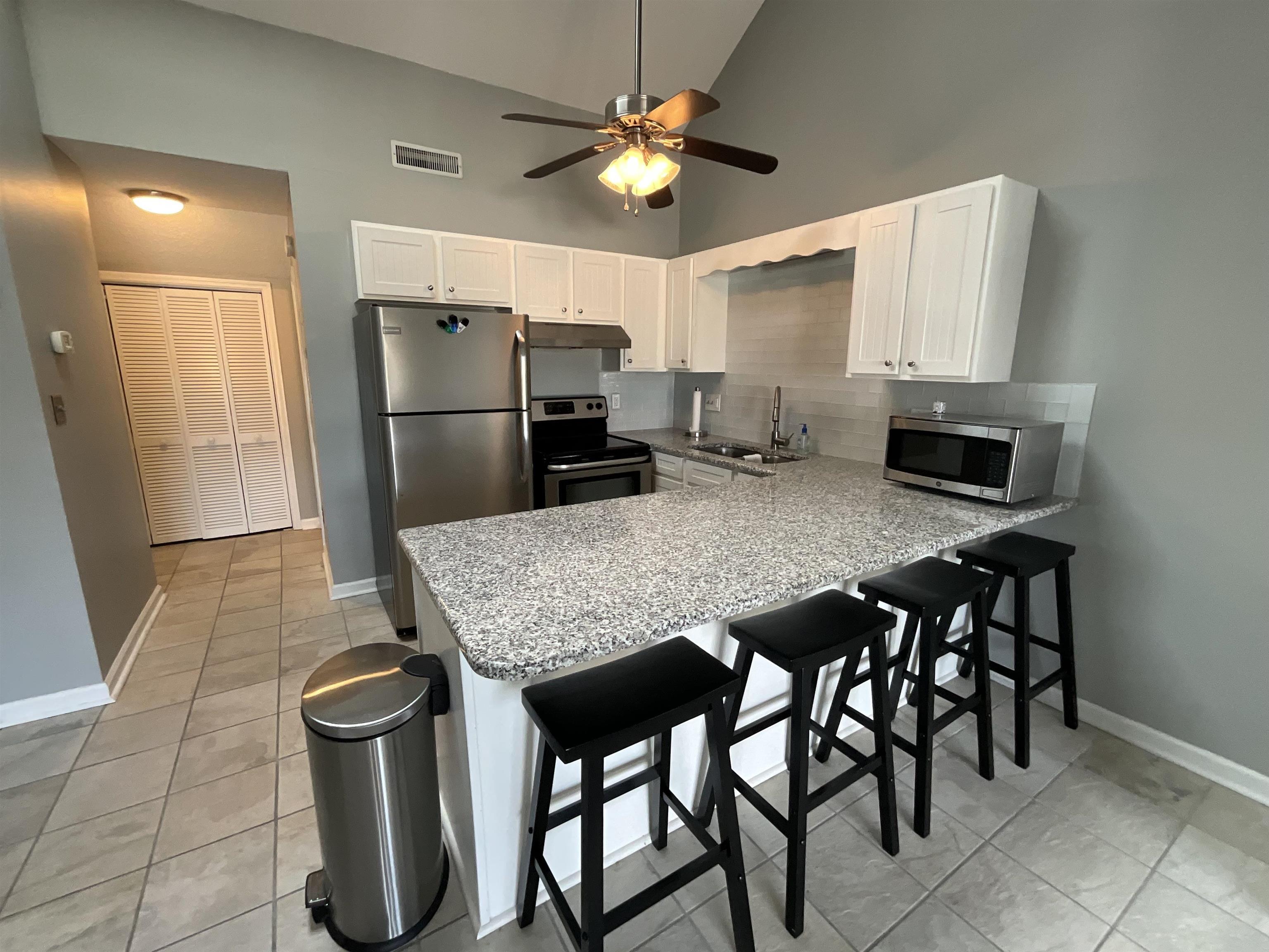 Image 4: Kitchen featuring white cabinets, stainless steel Image 4: Kitchen featuring white cabinets, stainless steel