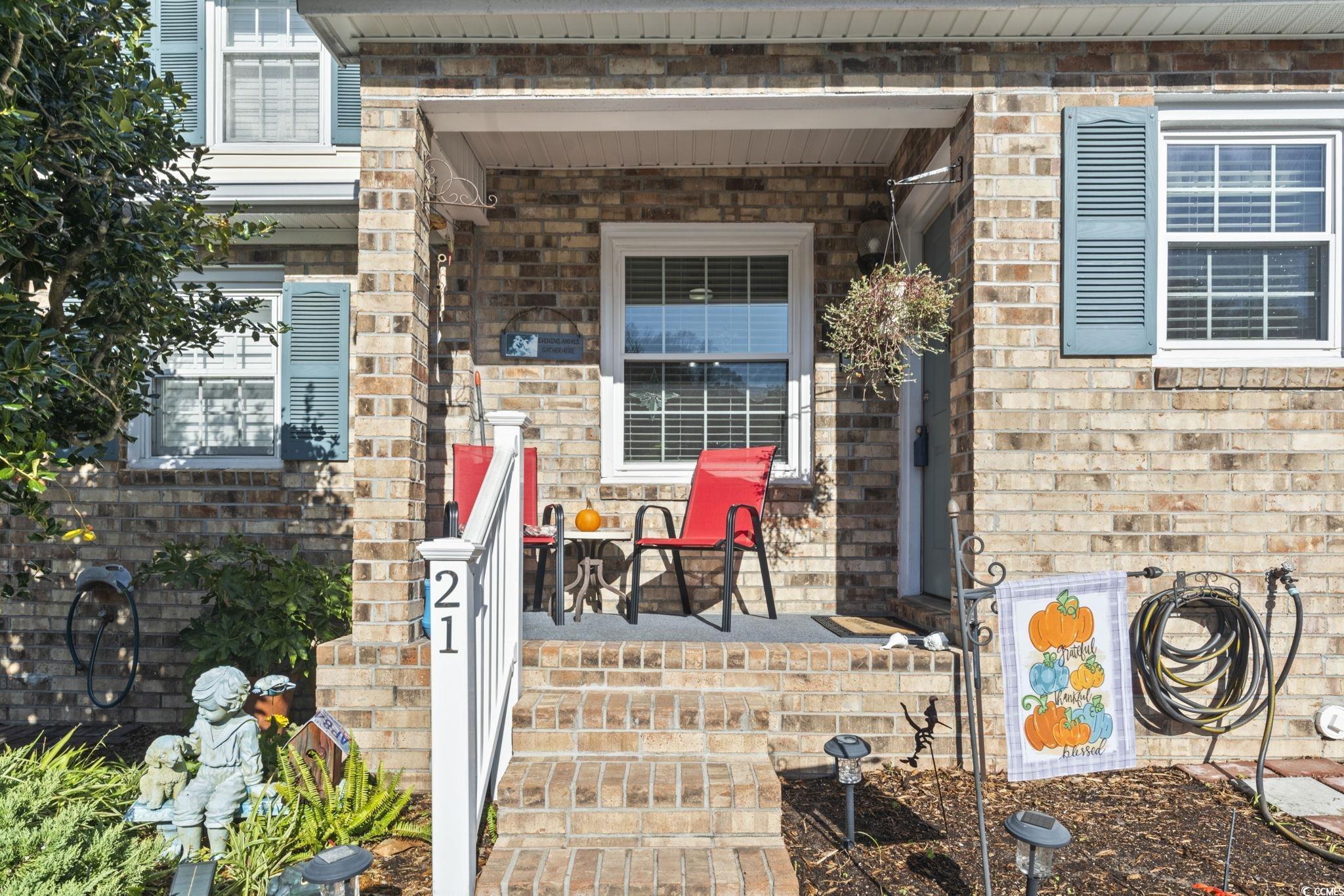 Image 2: Property entrance featuring brick siding and cover Image 2: Property entrance featuring brick siding and cover
