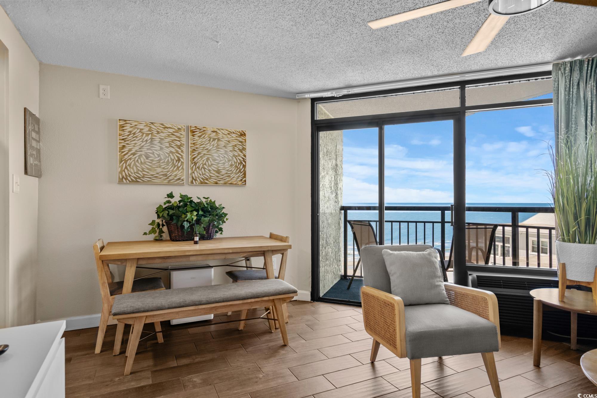 Image 4: Living area with a ceiling fan, a textured ceiling