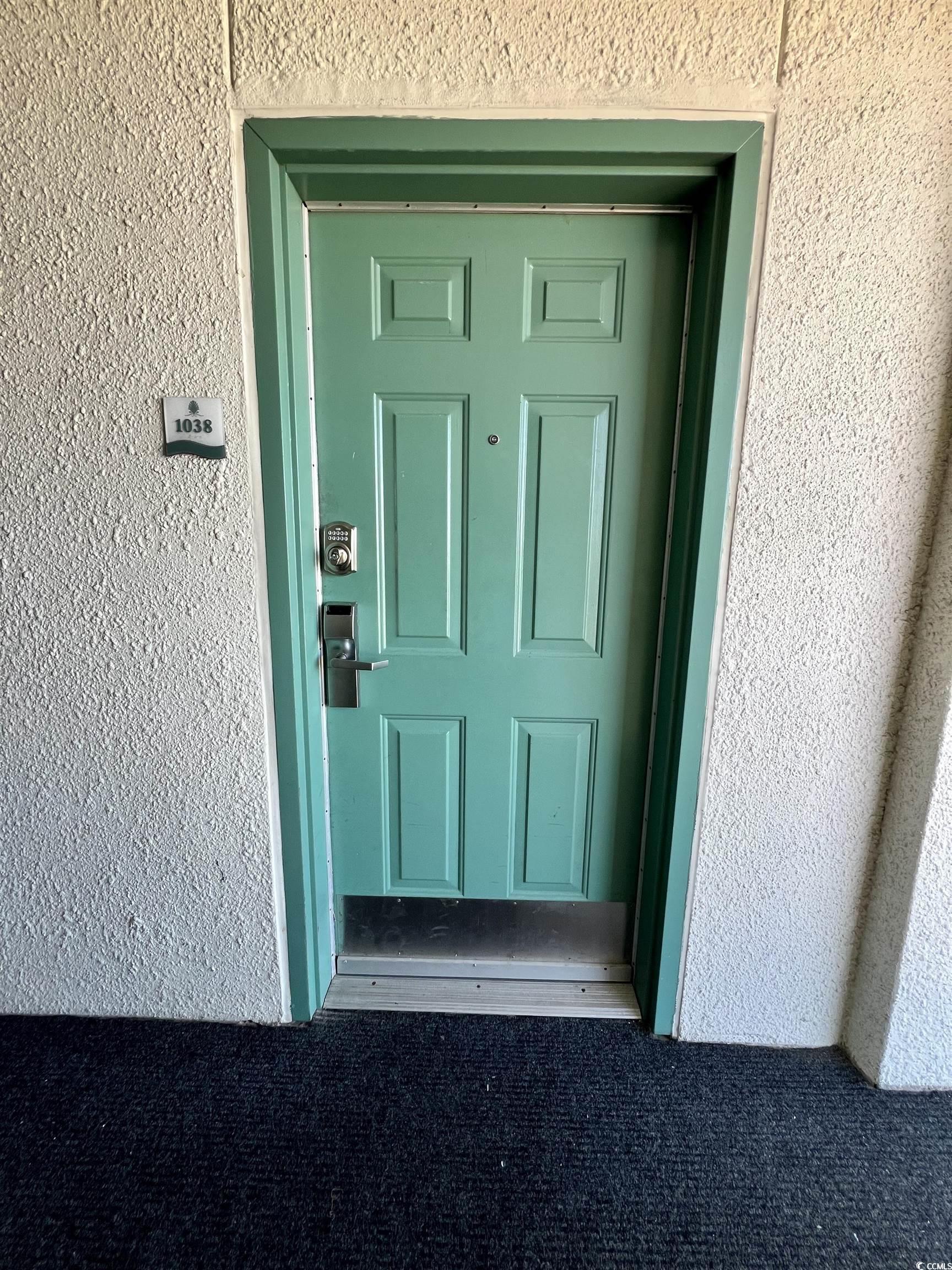 Image 2: Entrance to property featuring stucco siding