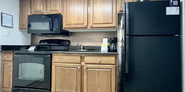 Image 4: Kitchen with dark countertops, black appliances, l Image 4: Kitchen with dark countertops, black appliances, l