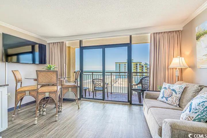 Image 4: Living room featuring floor to ceiling windows, a Image 4: Living room featuring floor to ceiling windows, a
