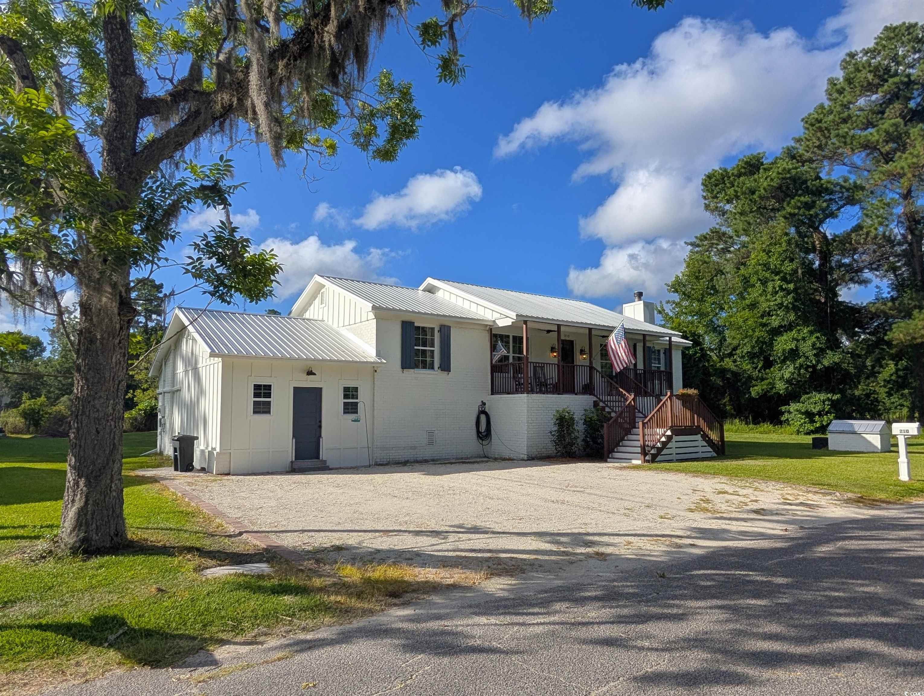 Image 2: View of front of property featuring a metal roof,