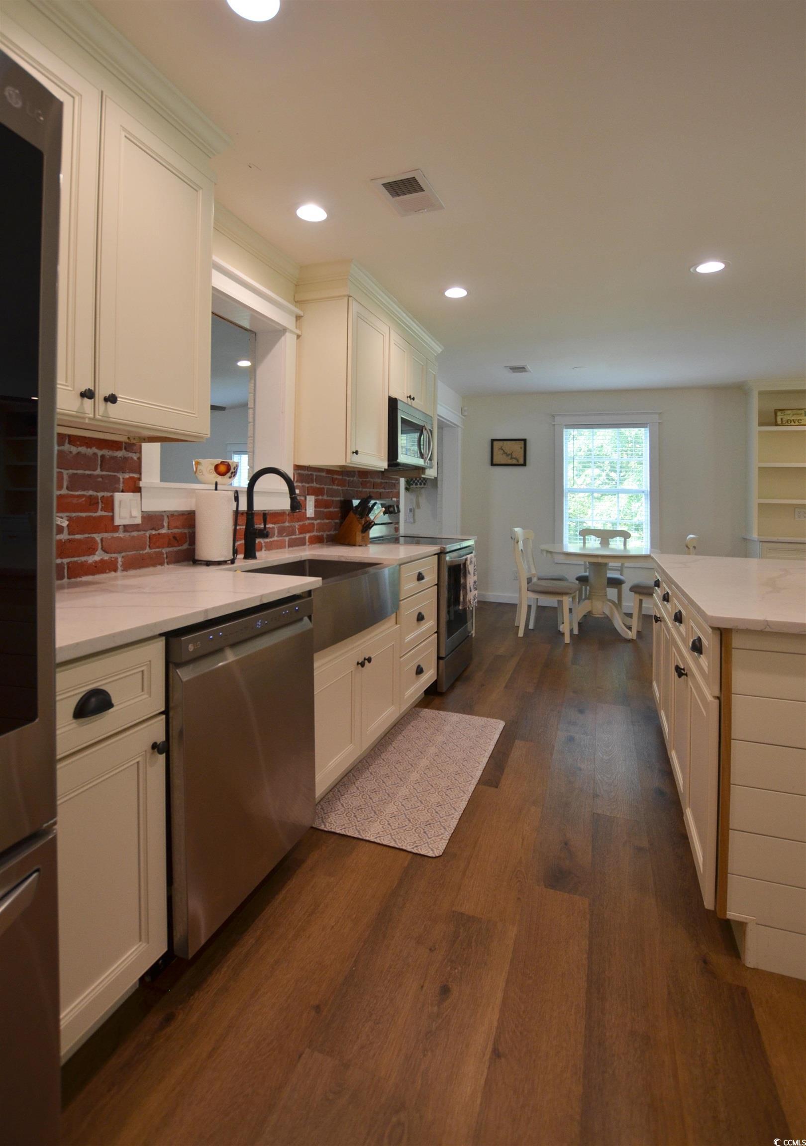 Image 3: Kitchen featuring stainless steel appliances, deco