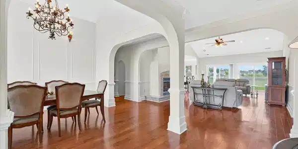 Image 4: Dining room with arched walkways, a decorative wal