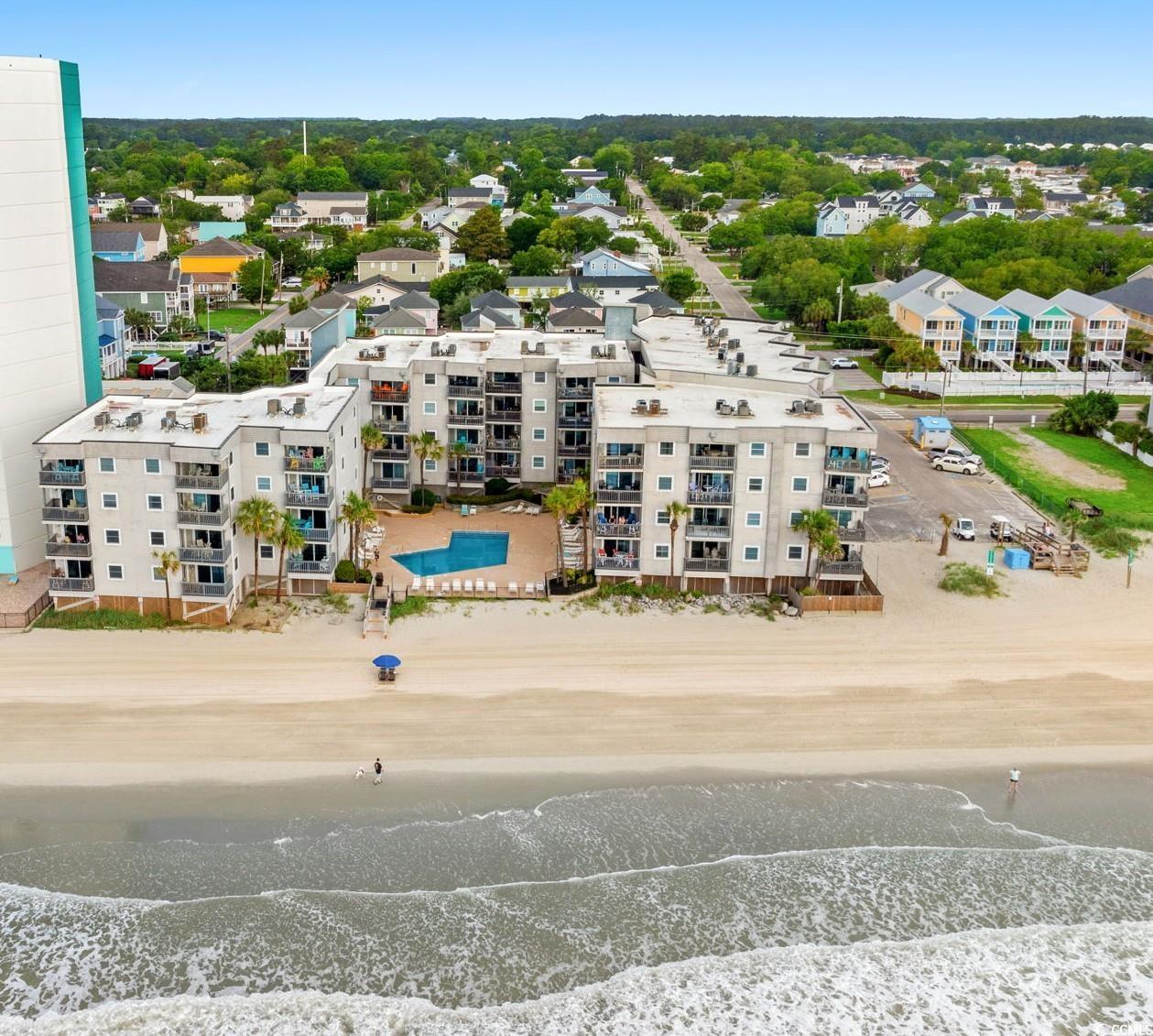 Image 1: Bird's eye view of expansive coastline and apartme