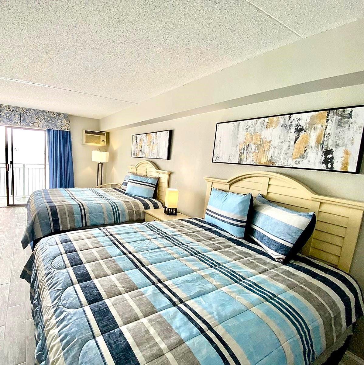 Image 2: Bedroom with a wall unit AC and a textured ceiling