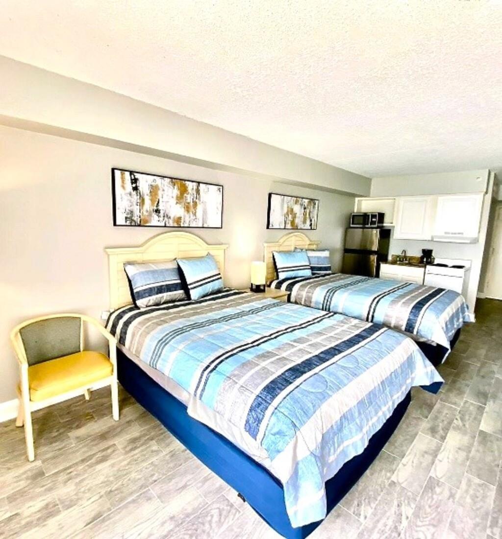 Image 3: Bedroom featuring a textured ceiling and light woo
