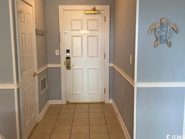 Image 3: Doorway to outside featuring tile patterned floori