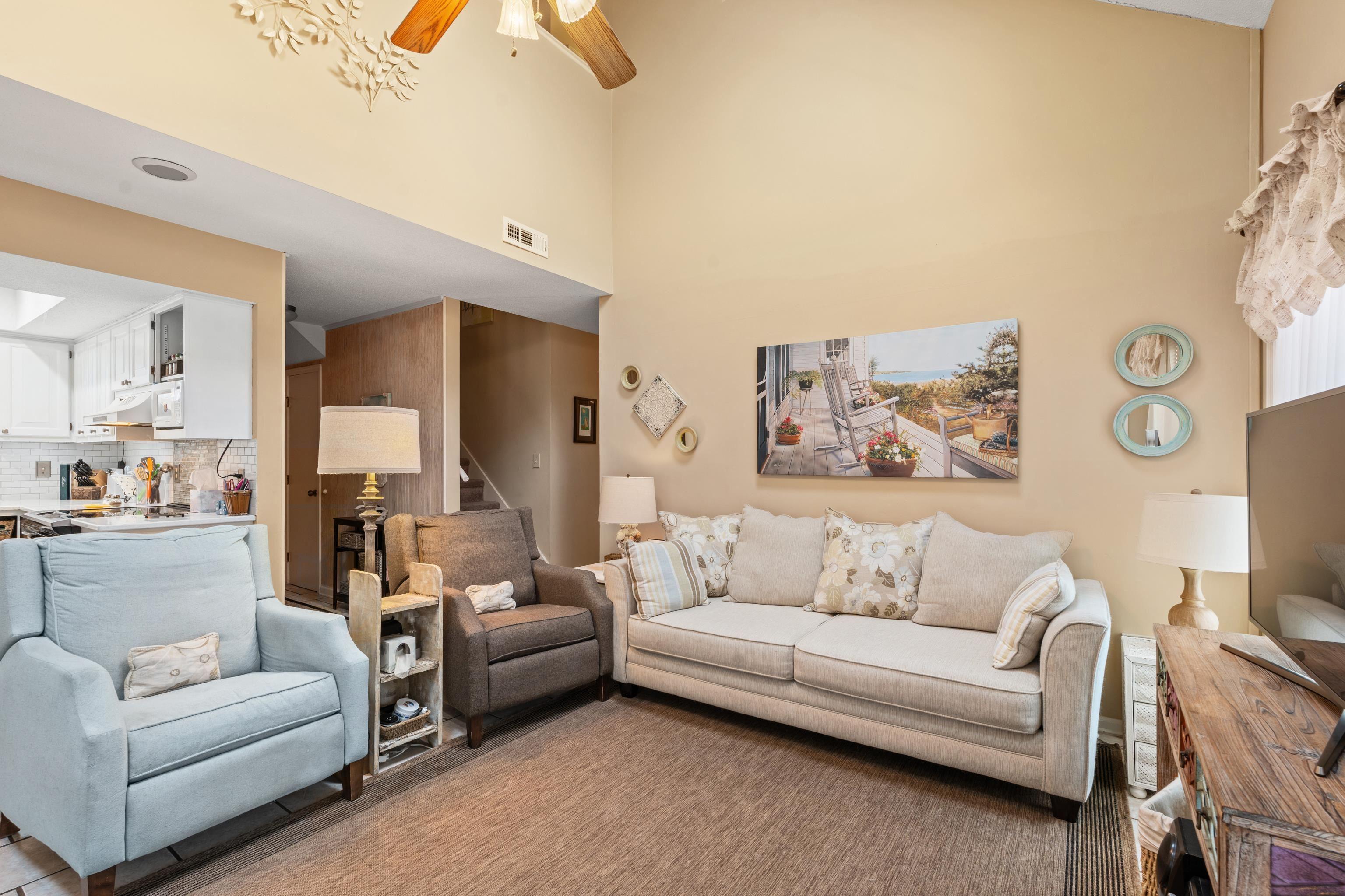 Image 3: Living area with a ceiling fan, stairway, and a to Image 3: Living area with a ceiling fan, stairway, and a to