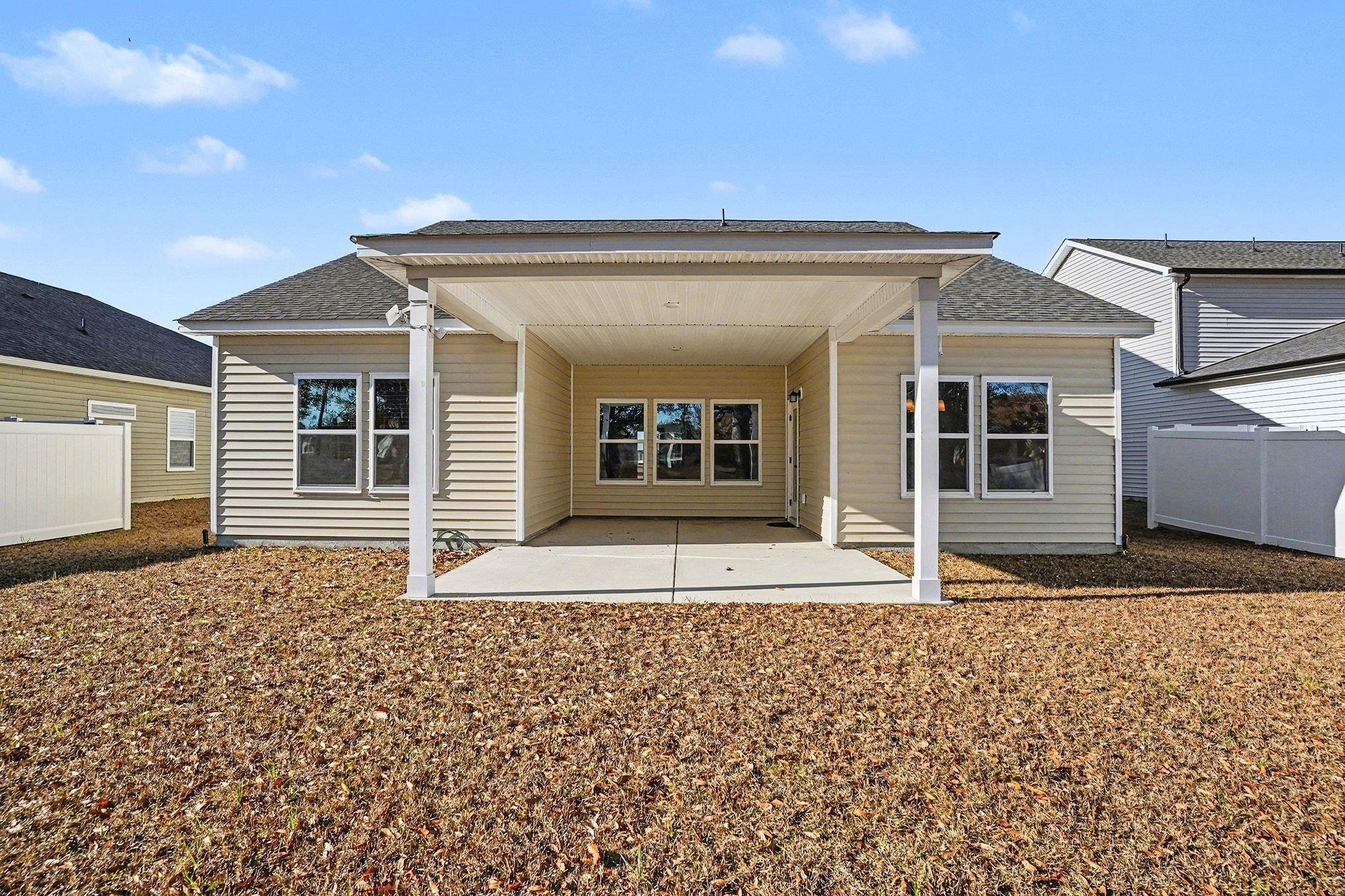 Image 3: Back of house featuring a patio area and roof with Image 3: Back of house featuring a patio area and roof with