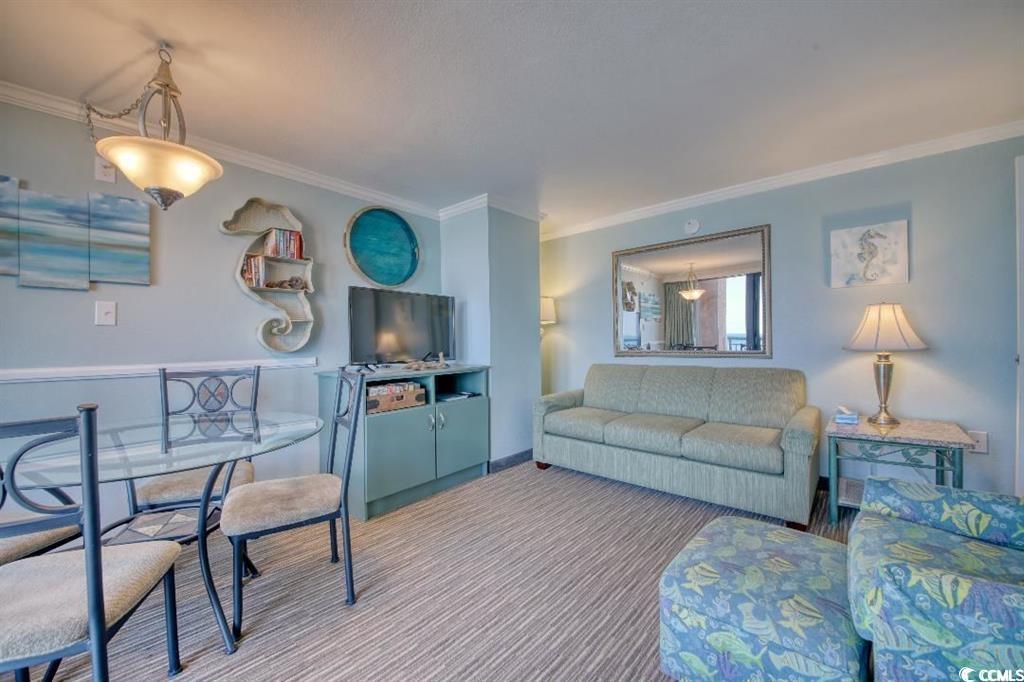 Image 4: Carpeted living room with ornamental molding