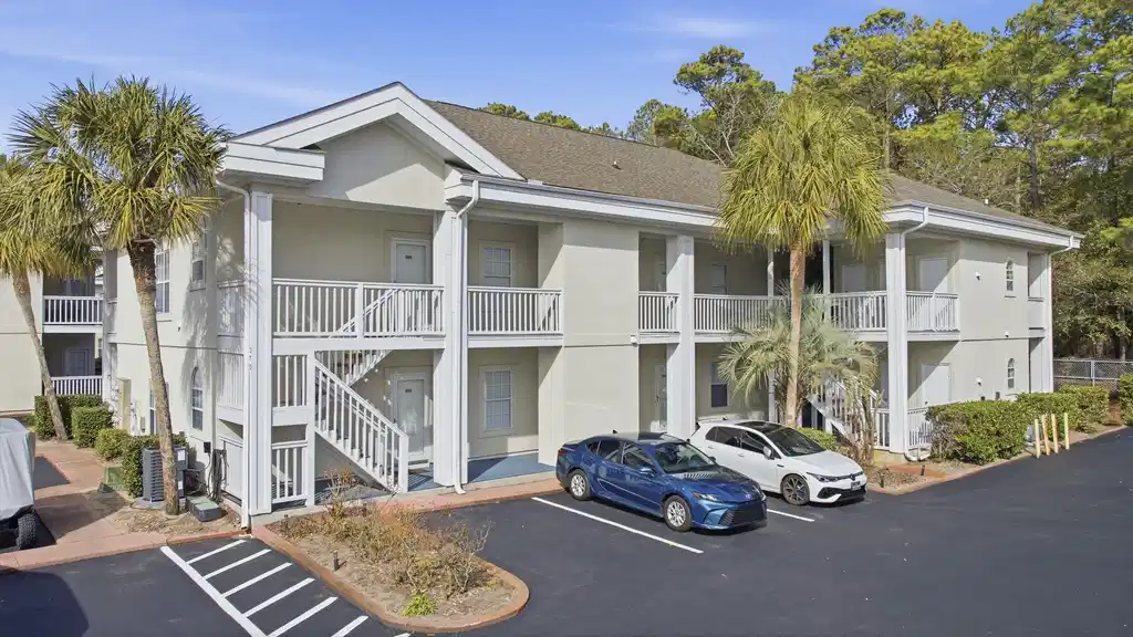 Image 1: View of condo building from parking lot.
