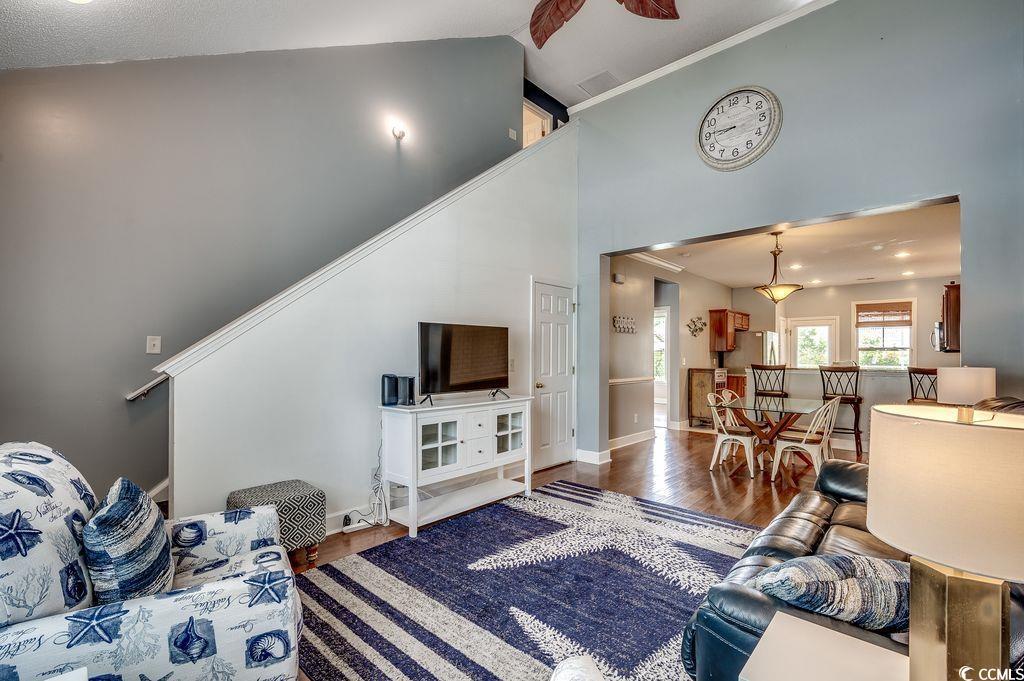 Image 3: Living area with wood finished floors and high vau Image 3: Living area with wood finished floors and high vau