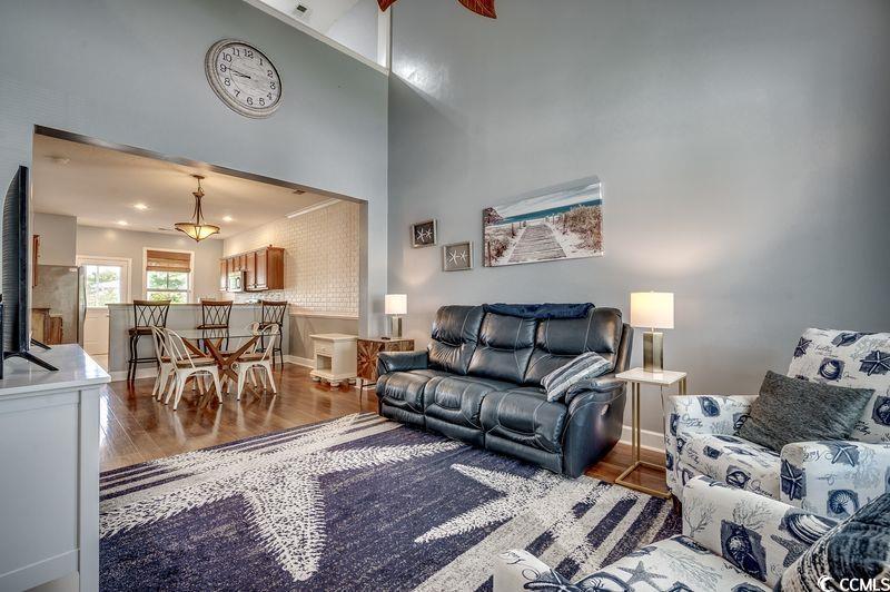 Image 4: Living area featuring wood finished floors and a t Image 4: Living area featuring wood finished floors and a t