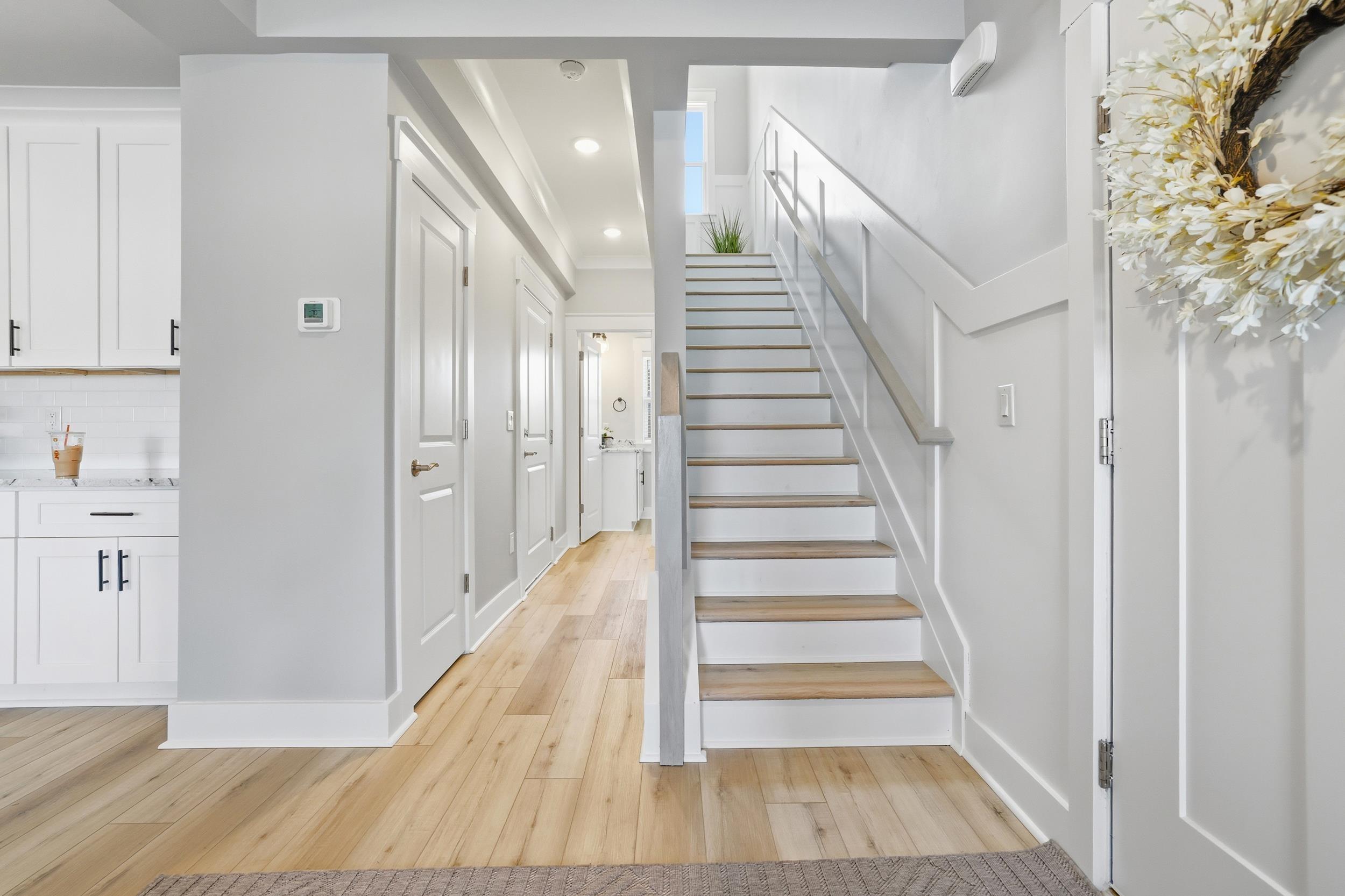 Image 4: Stairs with recessed lighting, wood finished floor
