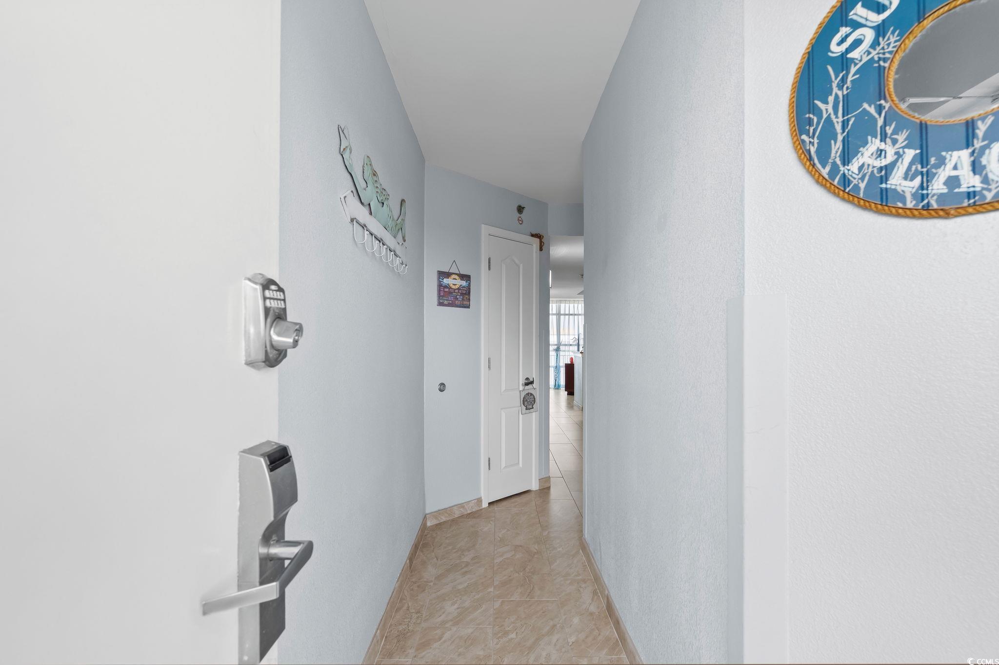 Image 2: Hallway featuring light tile patterned flooring Image 2: Hallway featuring light tile patterned flooring