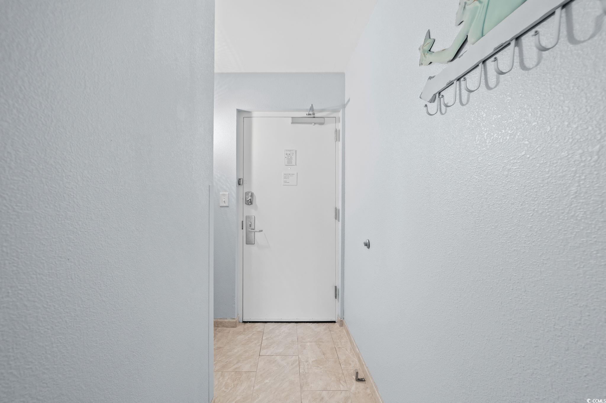 Image 3: Corridor with a textured wall and baseboards Image 3: Corridor with a textured wall and baseboards