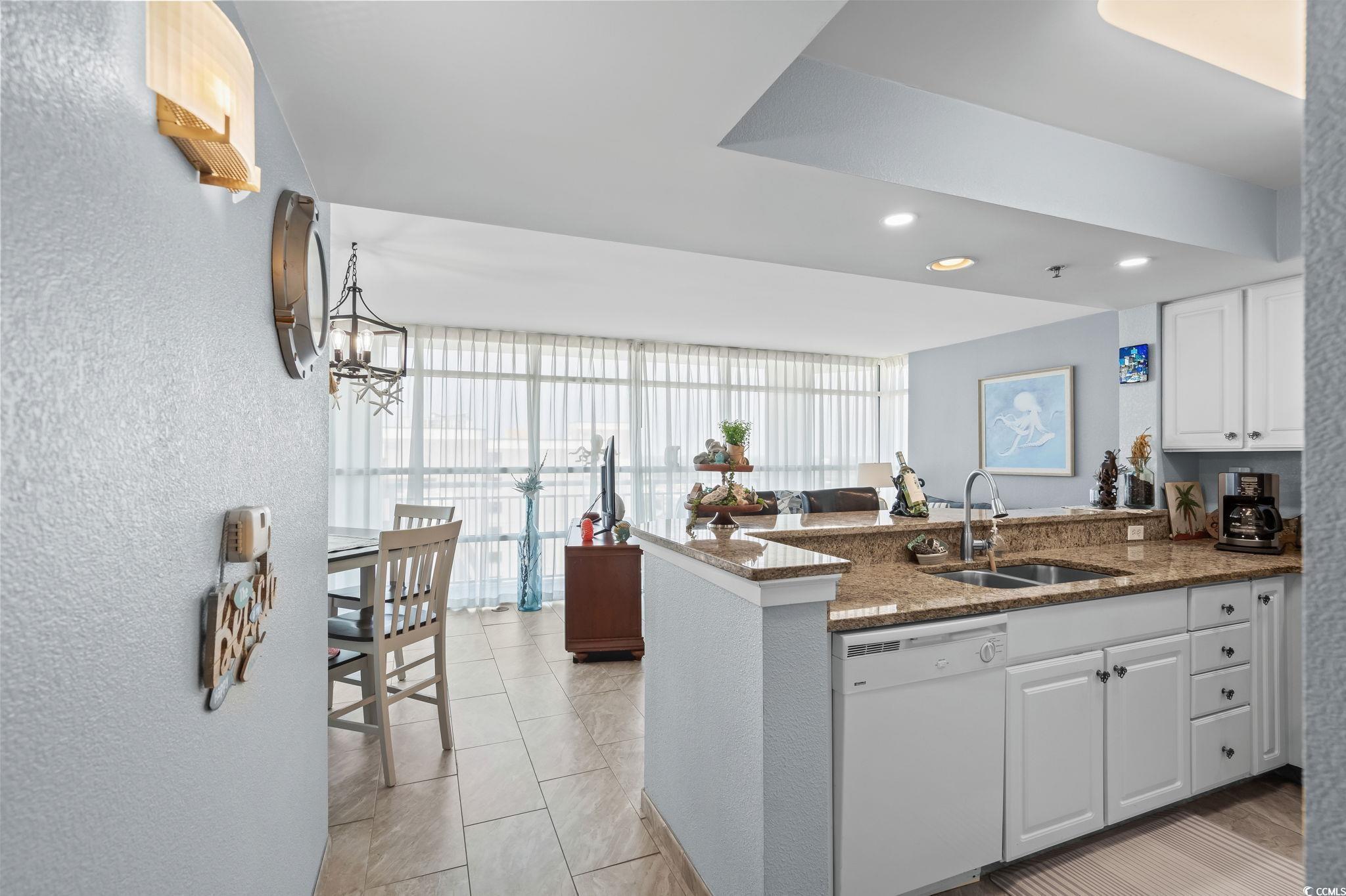 Image 4: Kitchen featuring dishwasher, a peninsula, white c Image 4: Kitchen featuring dishwasher, a peninsula, white c