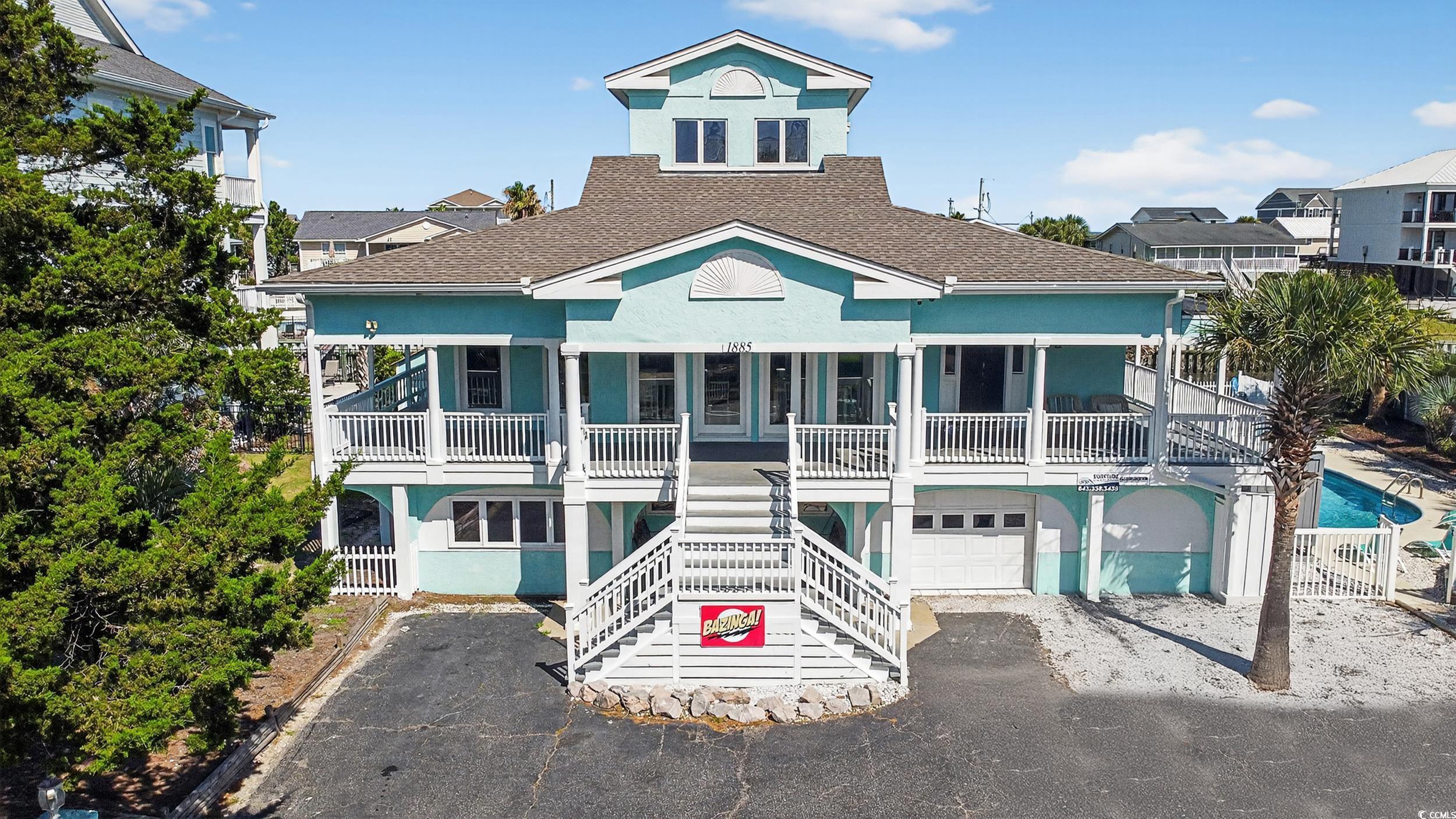 Image 1: View of property featuring stairway, driveway, and