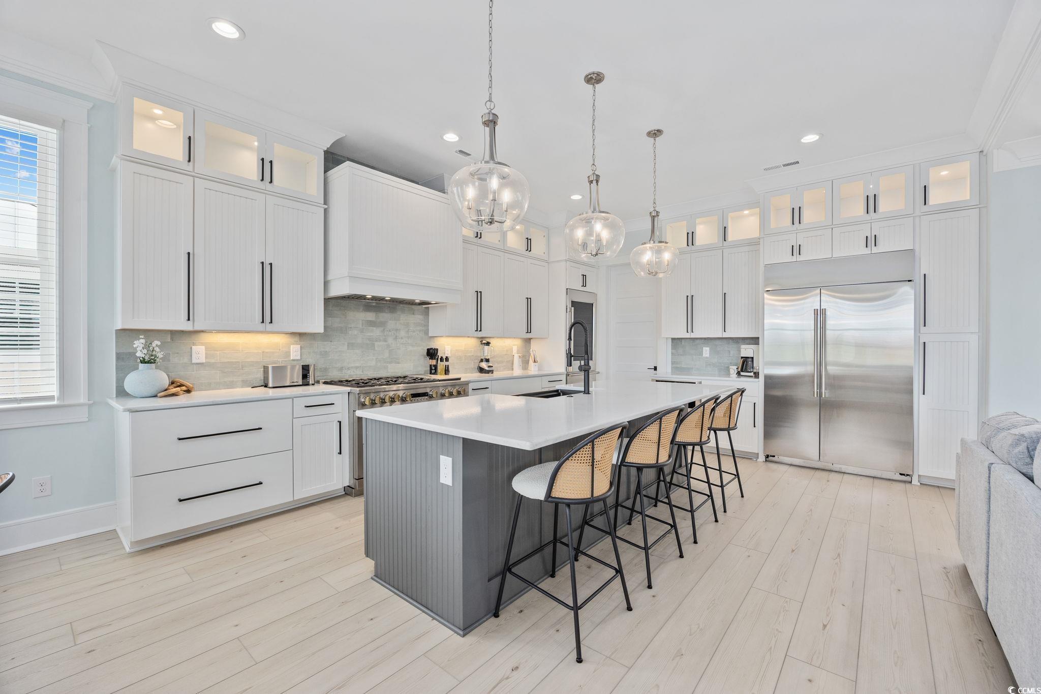 Image 4: Kitchen featuring high end appliances, light count