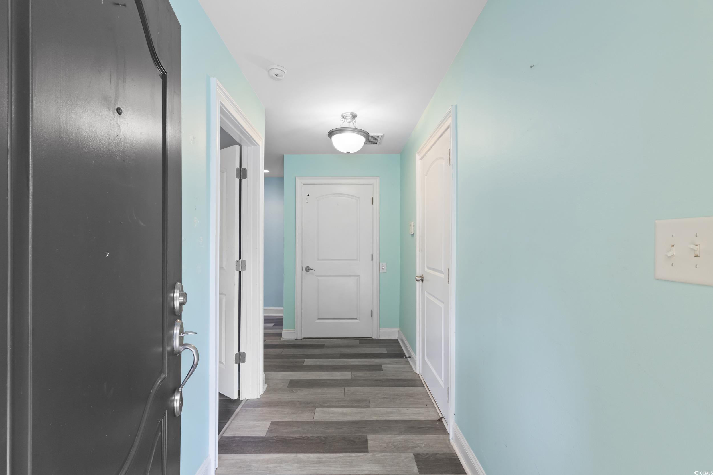 Image 4: Hall with wood finished floors and baseboards