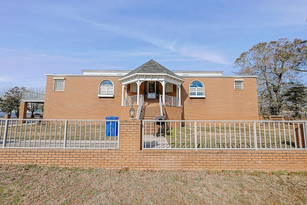 Image 1: View of front of house featuring a fenced front ya Image 1: View of front of house featuring a fenced front ya