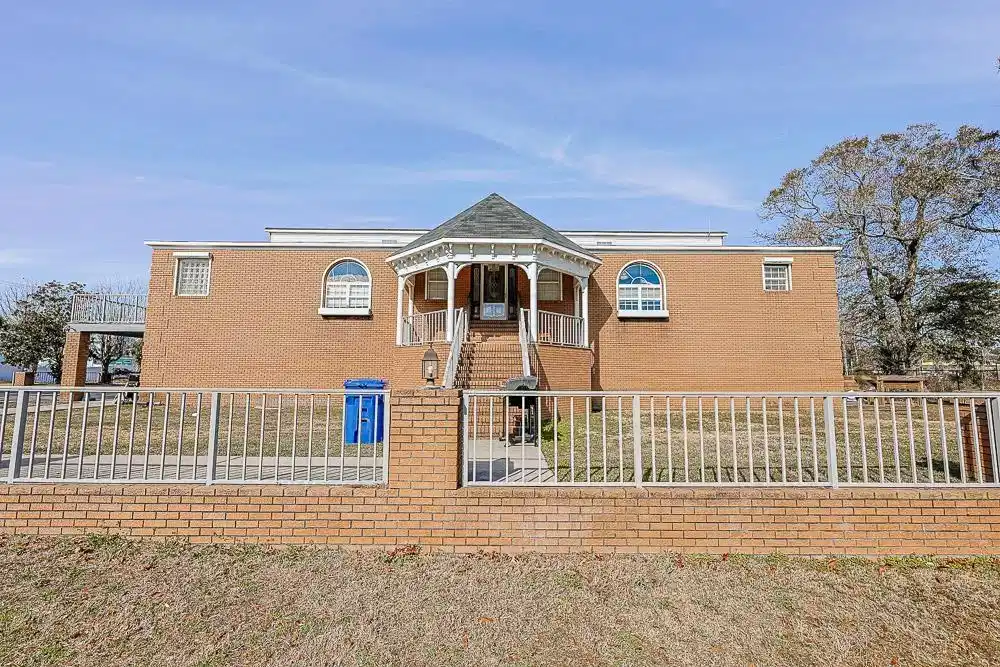 Image 1: View of front of house featuring a fenced front ya