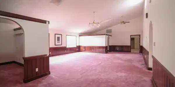 Image 4: Interior space with carpet flooring, wooden walls,