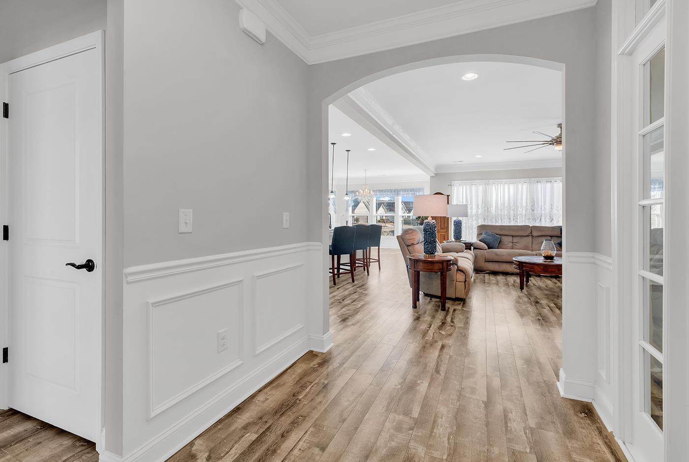 Image 3: Corridor featuring a wainscoted wall, a decorative Image 3: Corridor featuring a wainscoted wall, a decorative