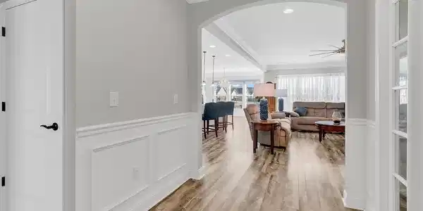 Image 3: Corridor featuring a wainscoted wall, a decorative Image 3: Corridor featuring a wainscoted wall, a decorative