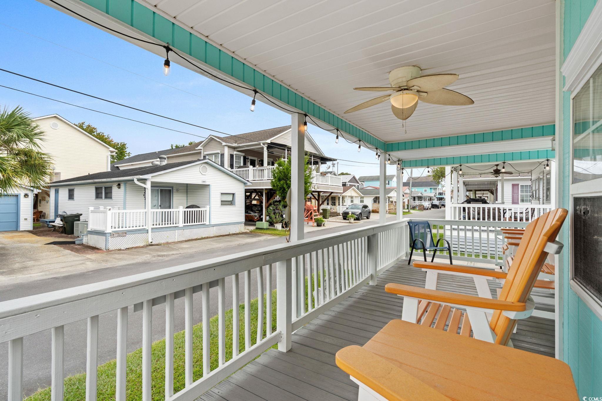 Image 3: Wooden terrace featuring a residential view and a