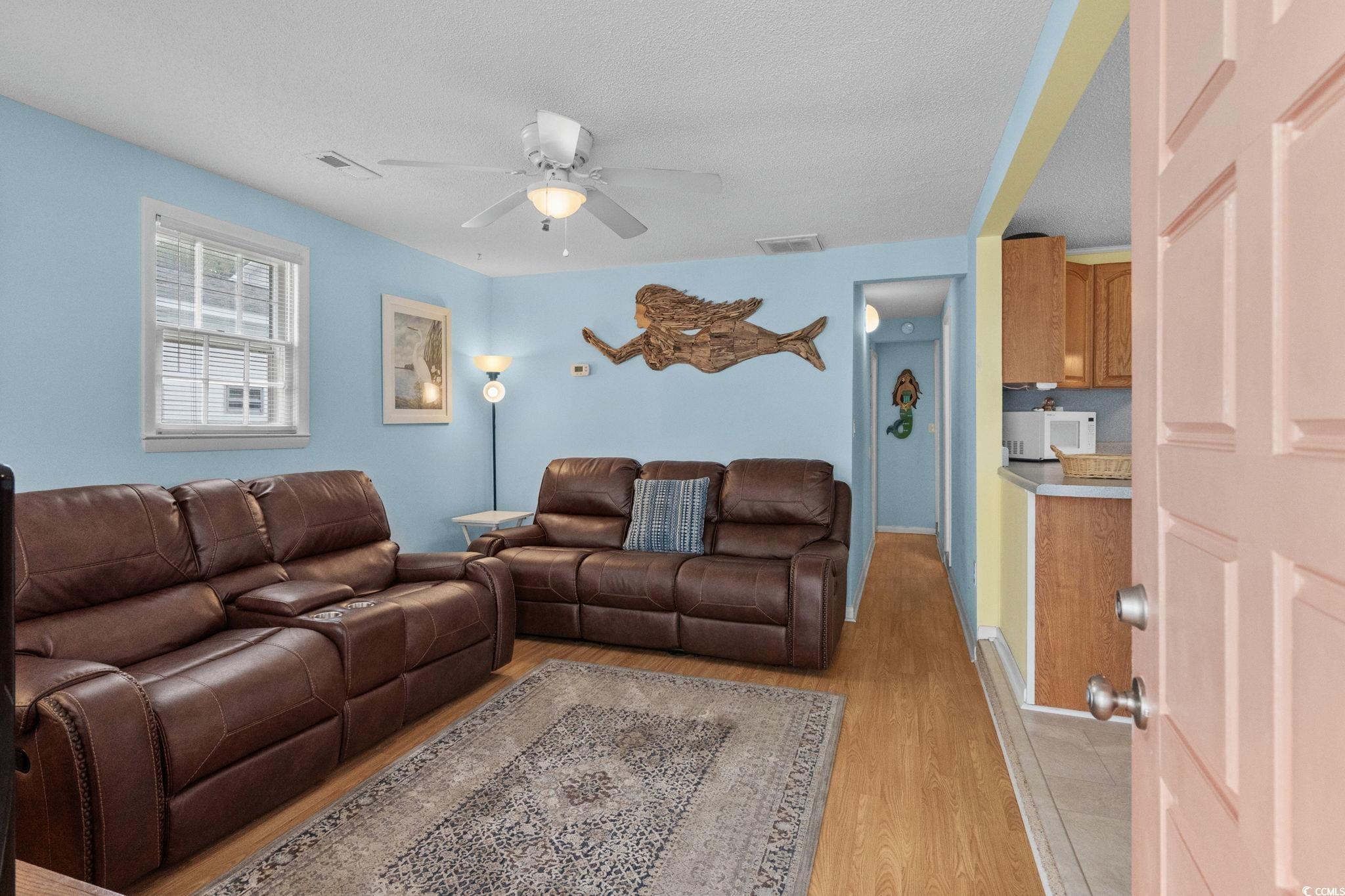 Image 4: Living area featuring light wood finished floors,