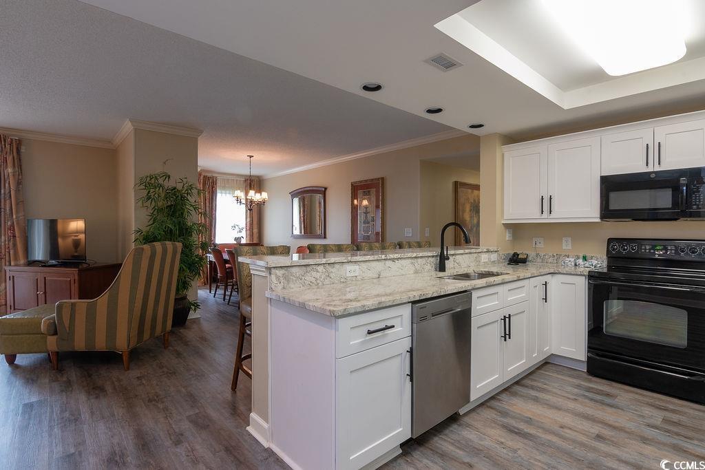 Image 3: Kitchen featuring black appliances, white cabinets Image 3: Kitchen featuring black appliances, white cabinets