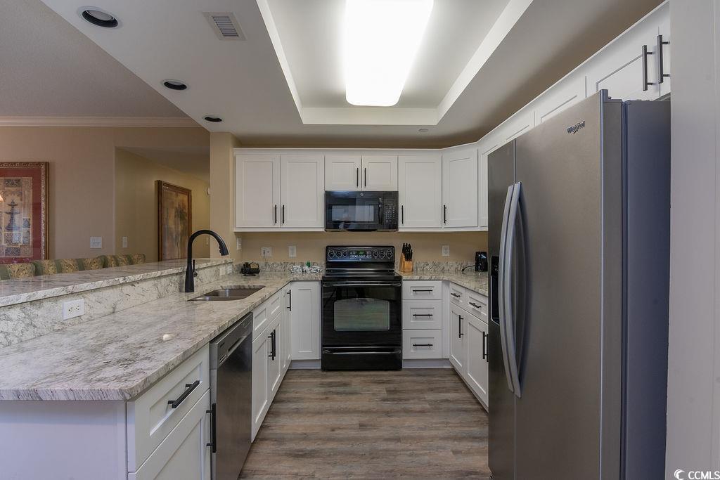 Image 4: Kitchen featuring black appliances, white cabinets Image 4: Kitchen featuring black appliances, white cabinets