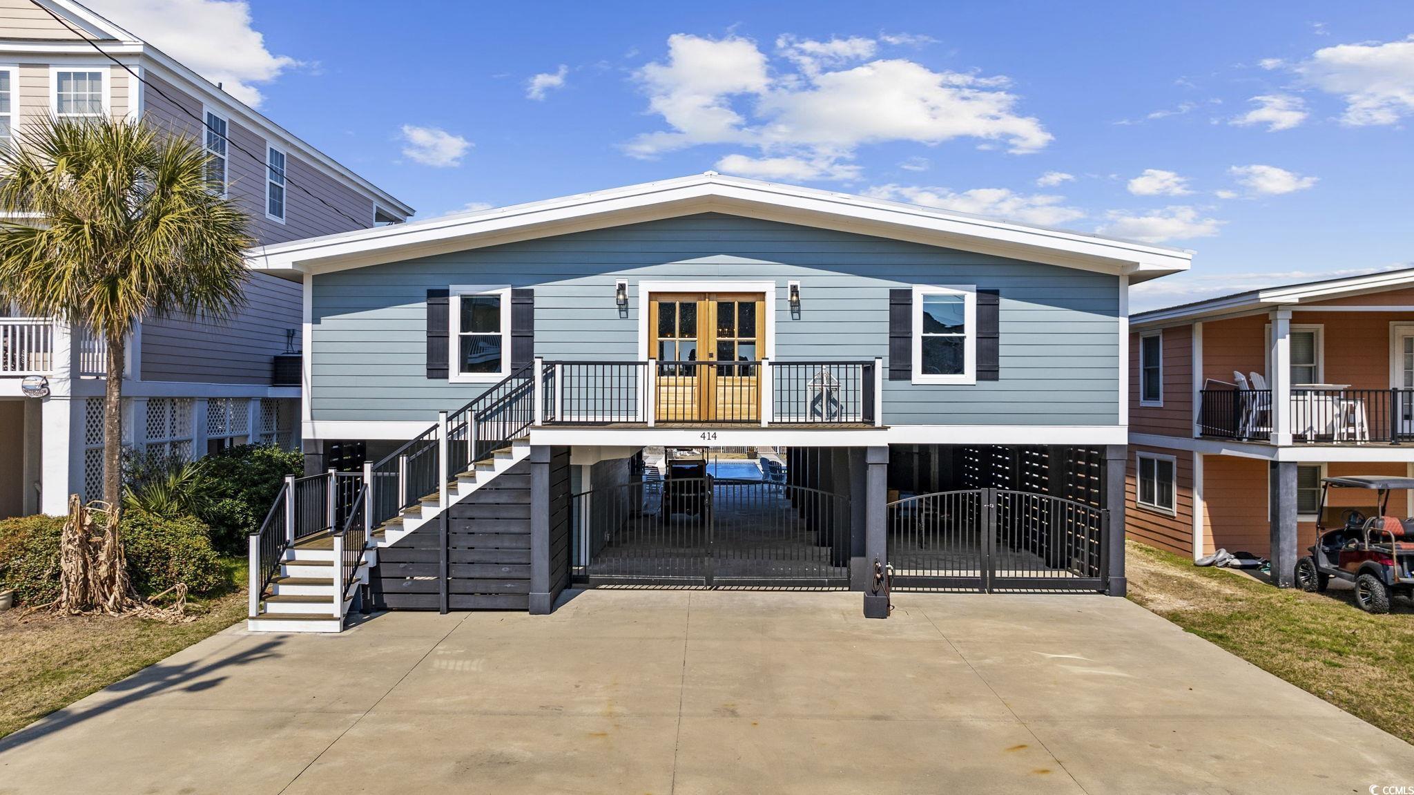 Image 1: View of front of property featuring a carport, dri