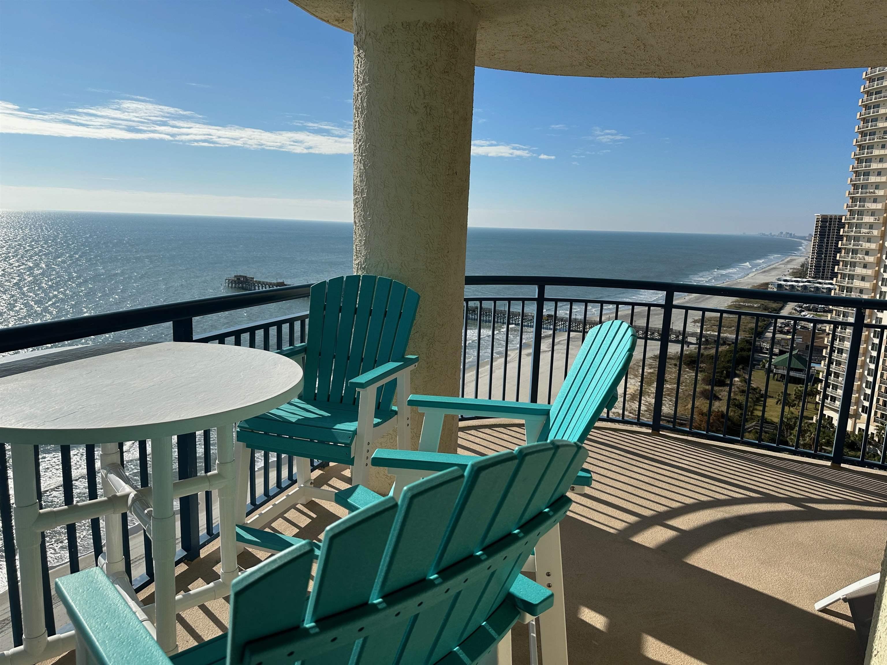 Image 3: Balcony with view of water and beach