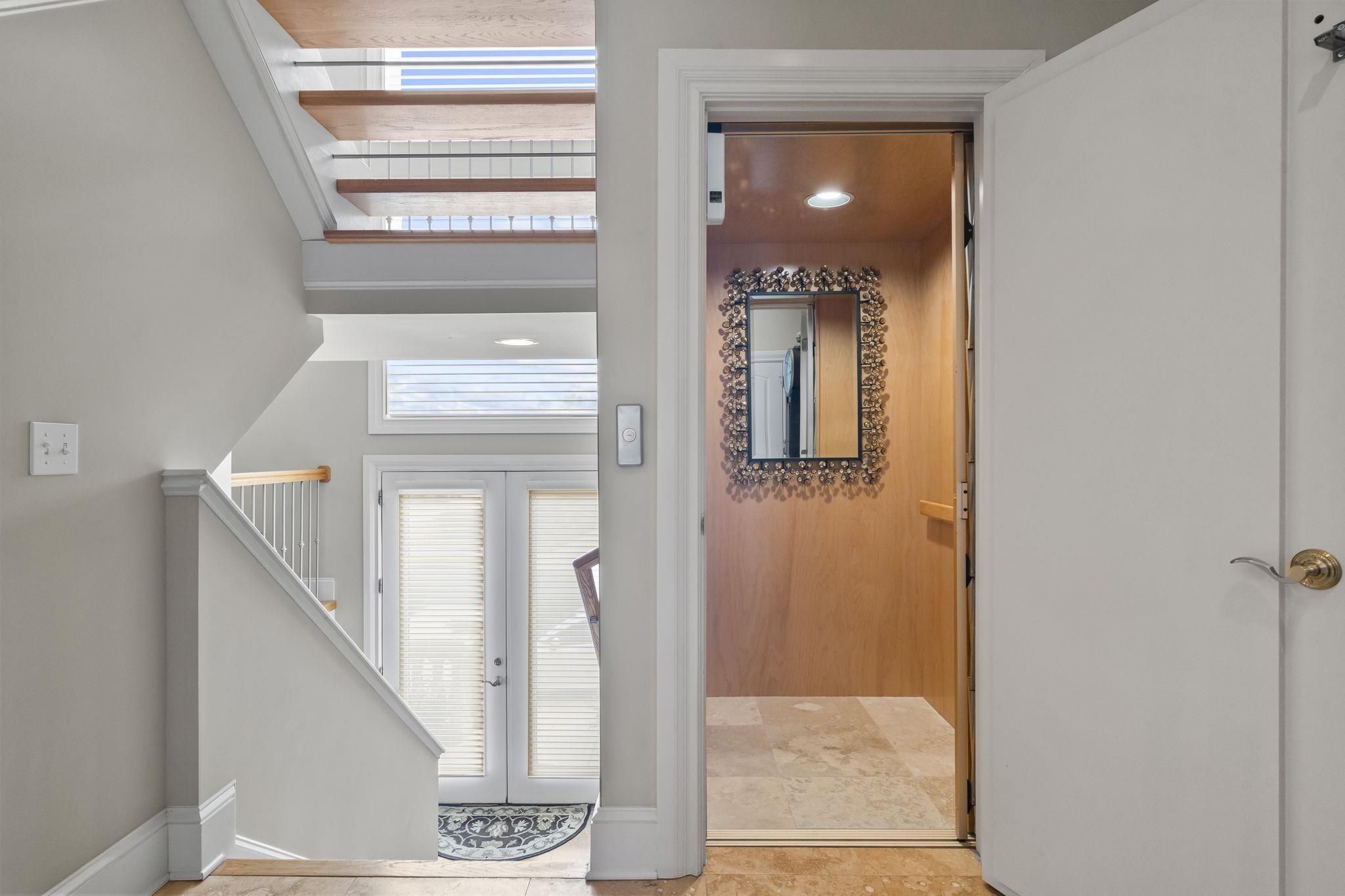 Image 3: Foyer featuring french doors, elevator, and recess Image 3: Foyer featuring french doors, elevator, and recess