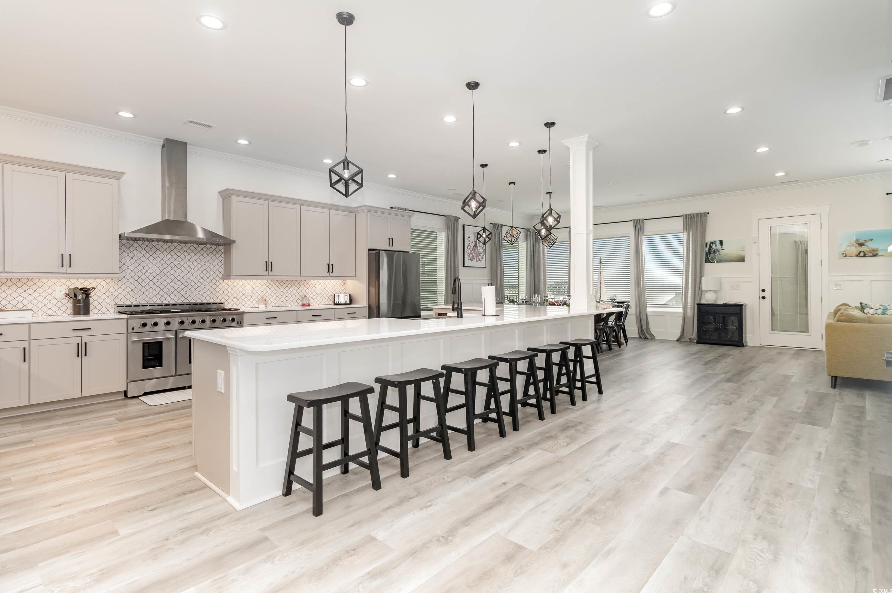 Image 4: Kitchen with a large island, a kitchen breakfast b