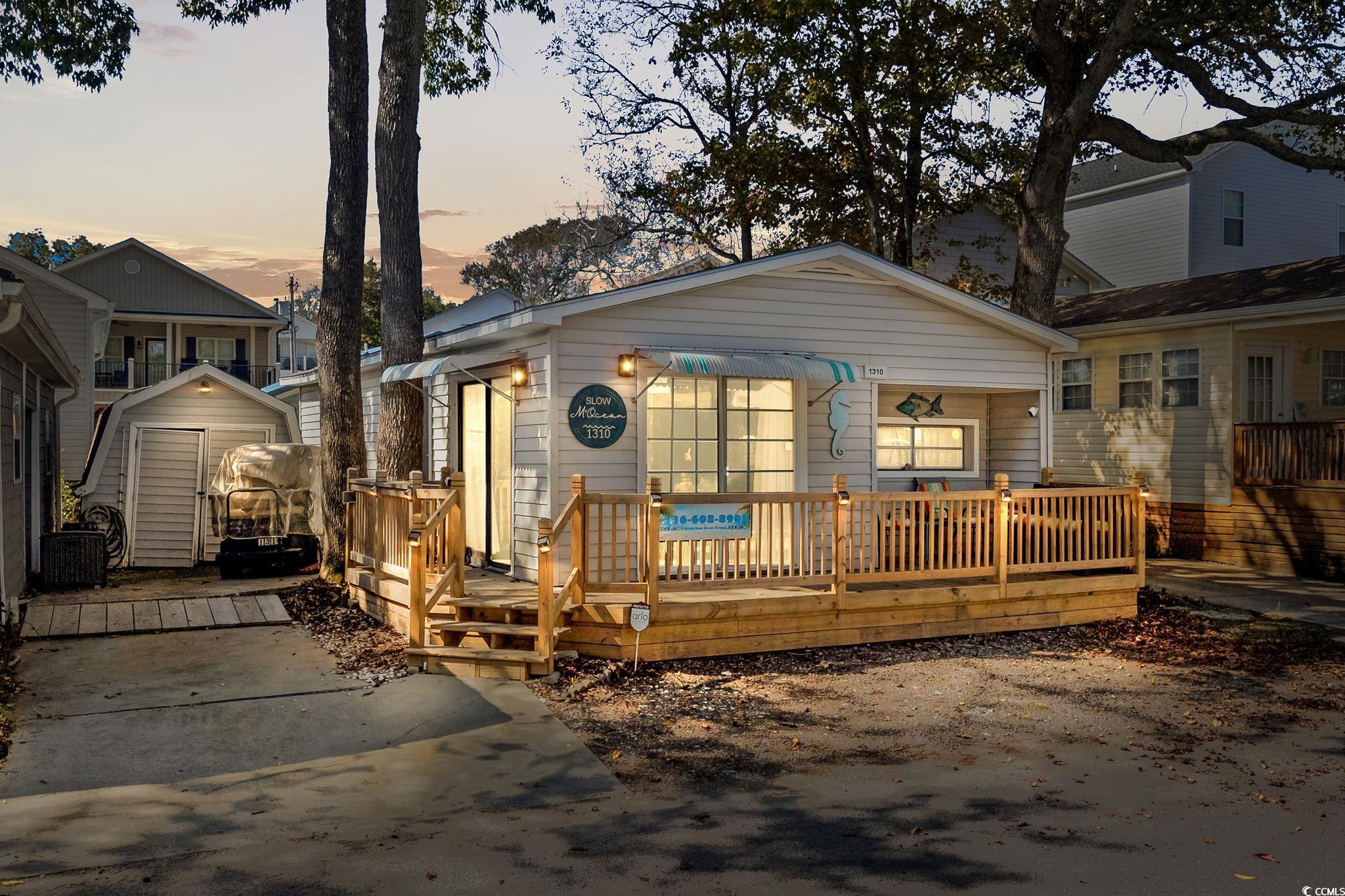 Image 1: View of front of property with a deck Image 1: View of front of property with a deck