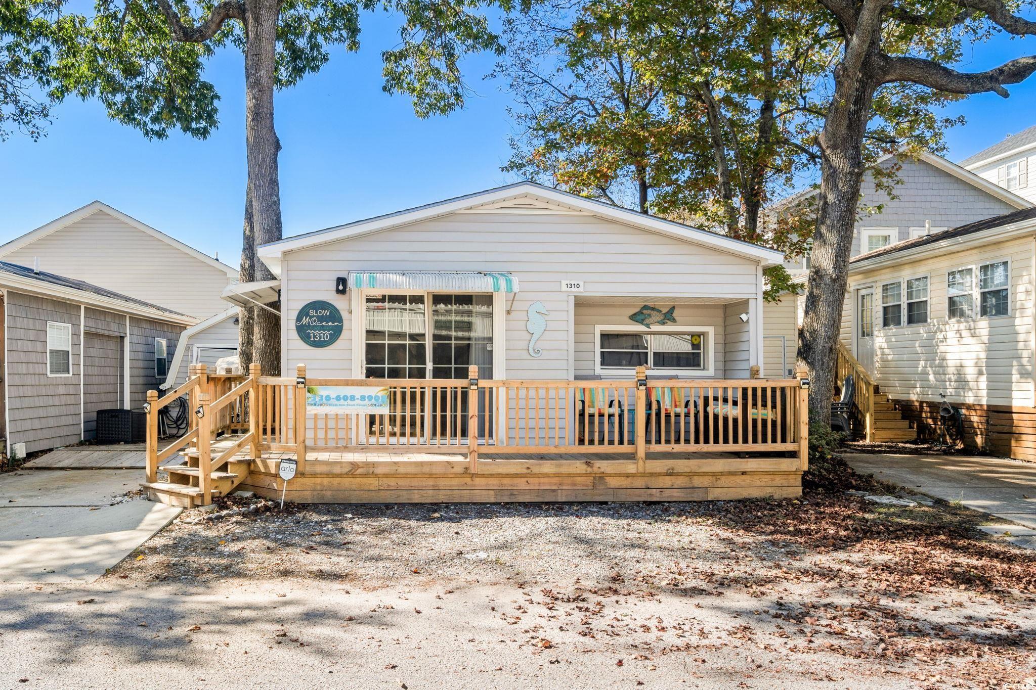 Image 2: View of front of property featuring a wooden deck Image 2: View of front of property featuring a wooden deck