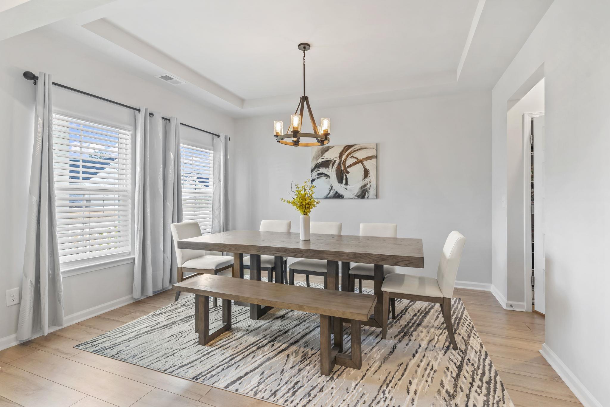 Image 3: Dining space featuring a tray ceiling, light wood- Image 3: Dining space featuring a tray ceiling, light wood-
