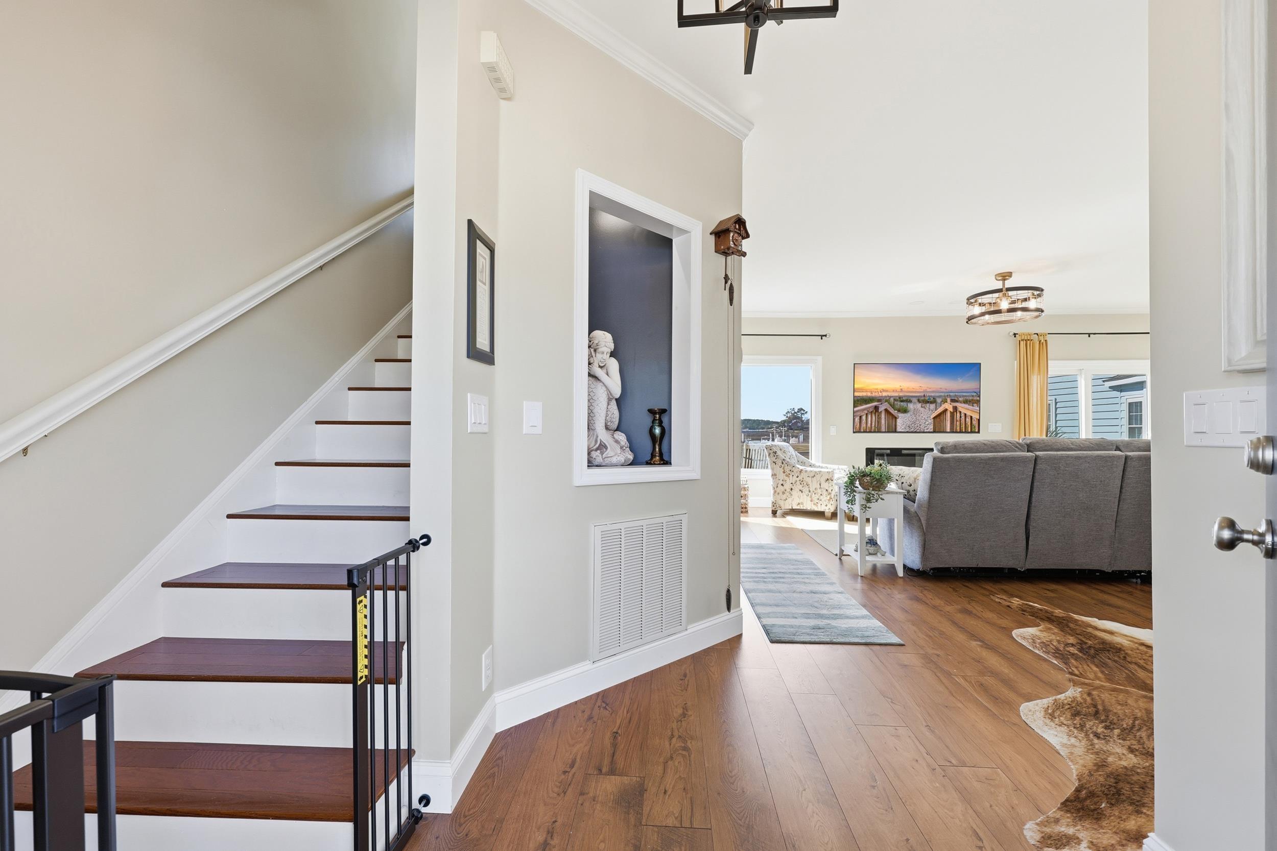 Image 3: Staircase with a chandelier, hardwood / wood-style