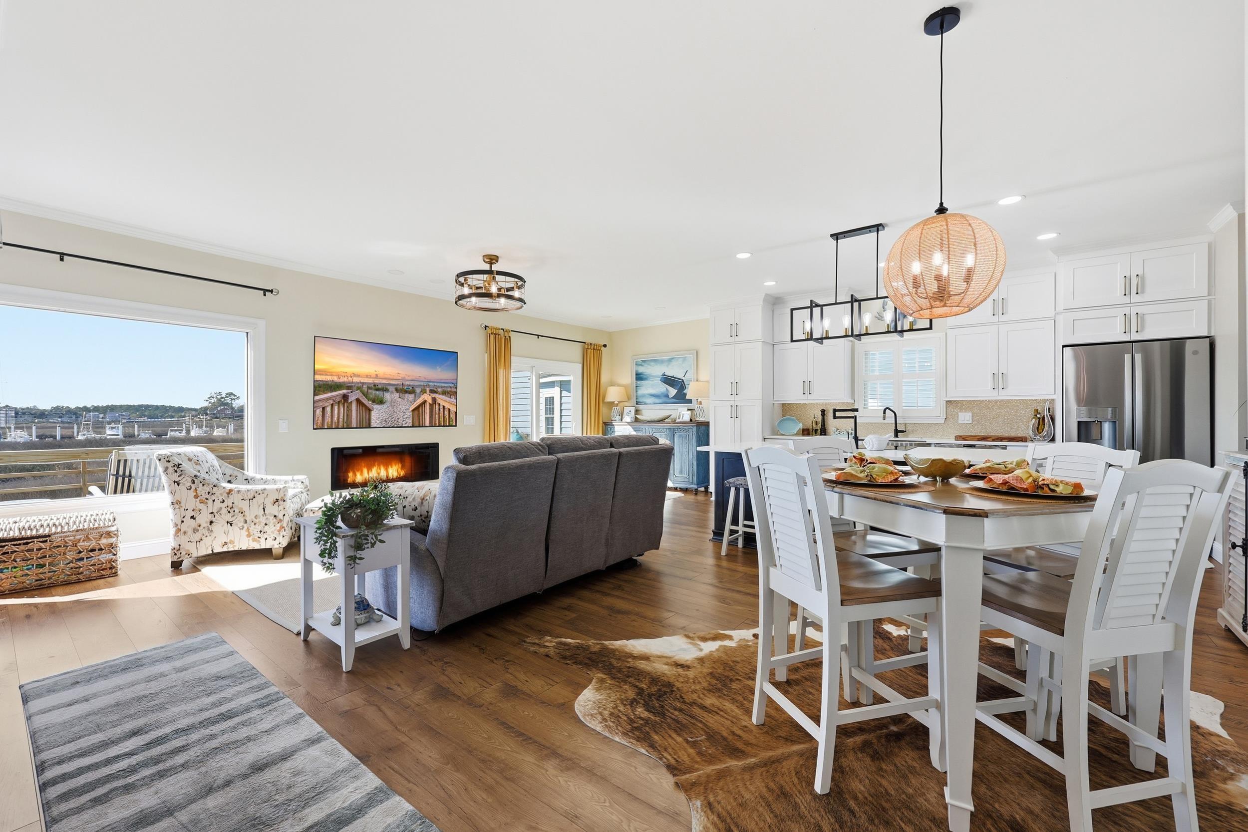 Image 4: Dining room featuring a chandelier, a warm lit fir