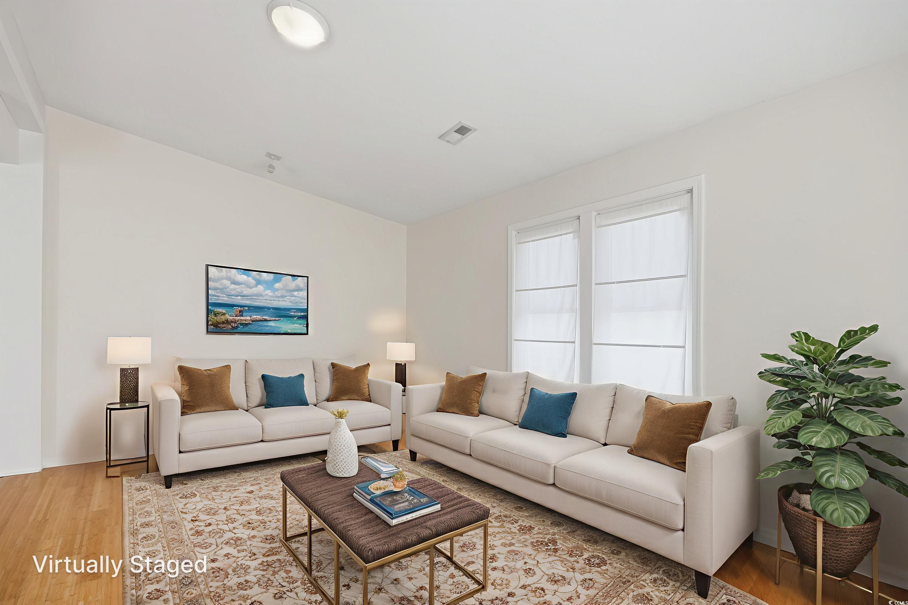 Image 3: Living area with wood finished floors