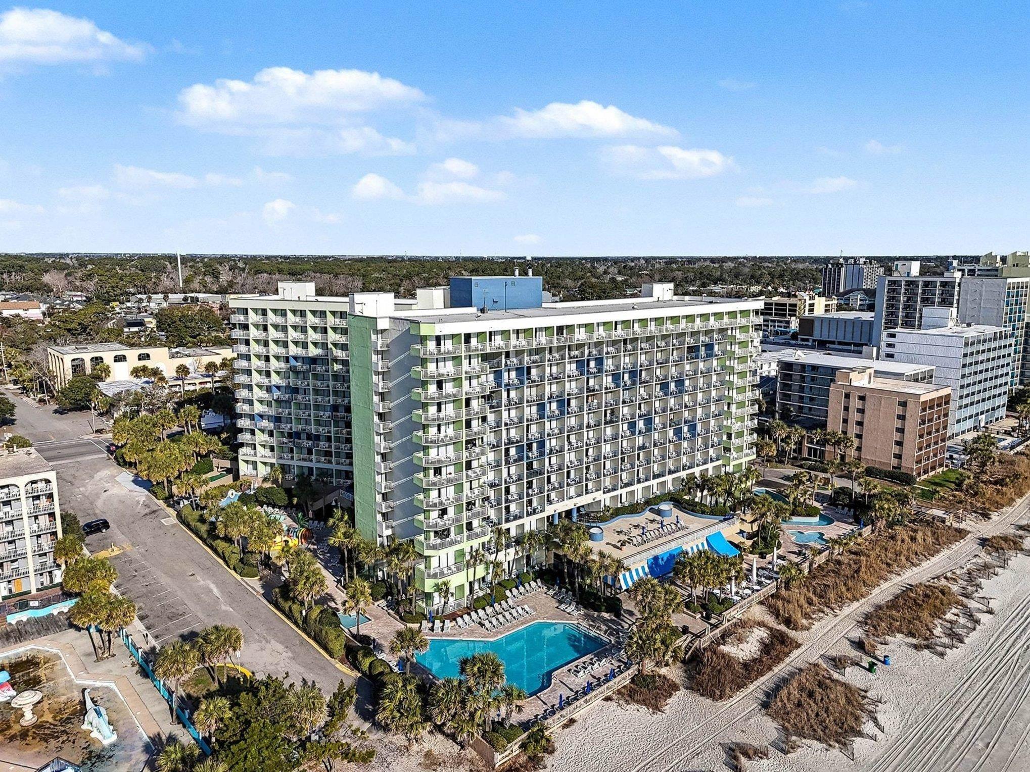 Image 2: Aerial view of a pool area and apartment complex