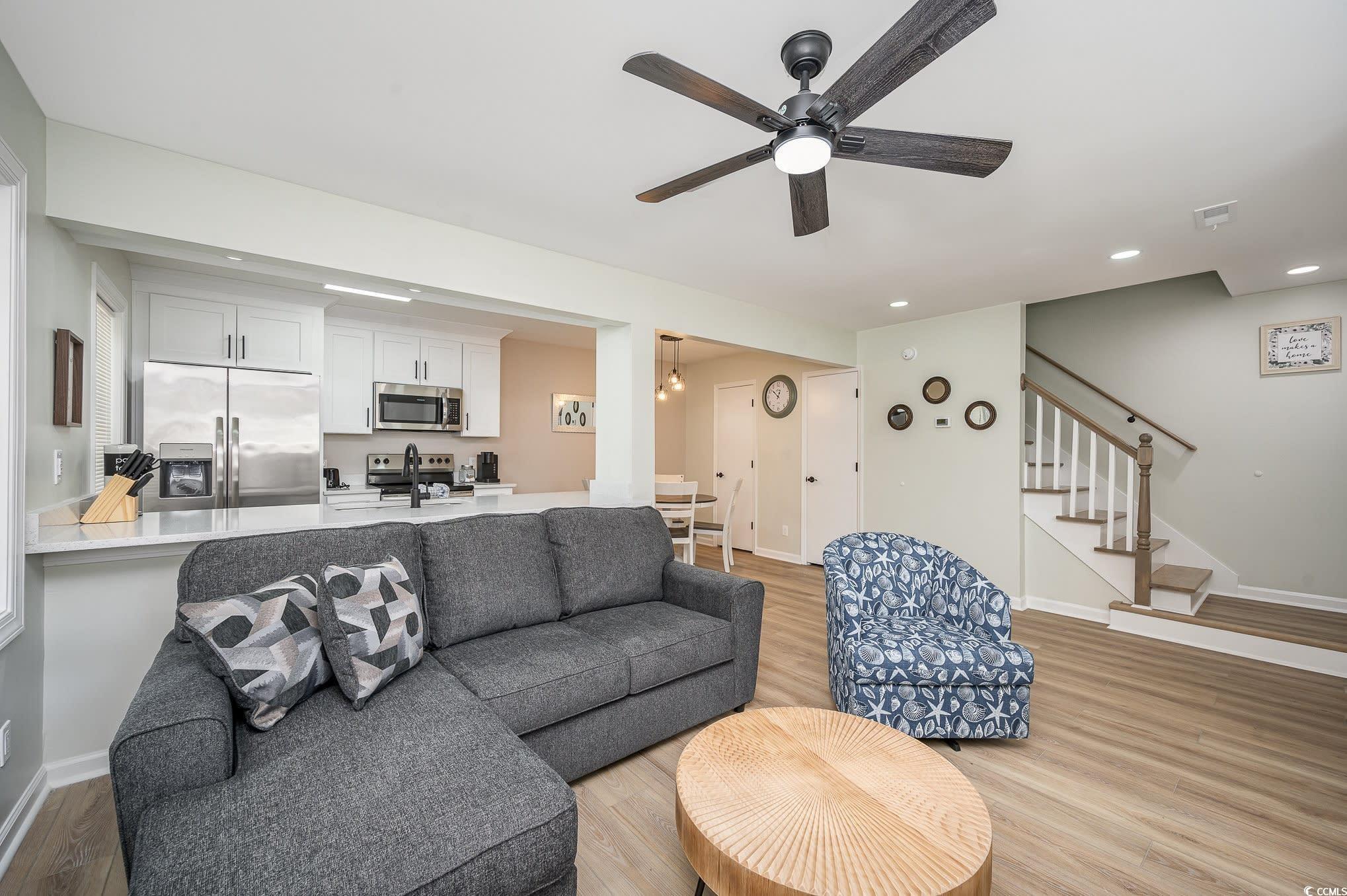 Image 3: Living room featuring light wood-style flooring, s